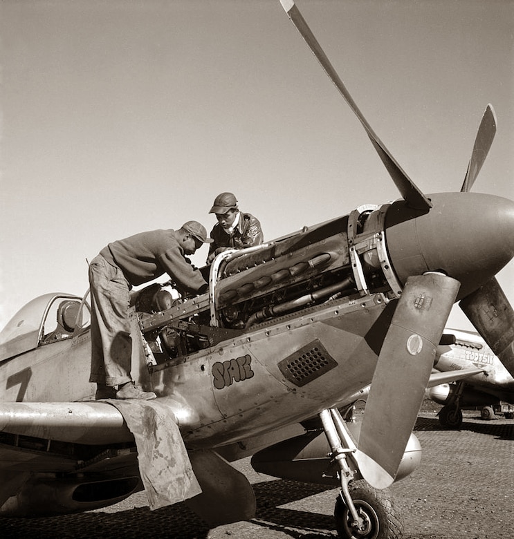 A picture of Tuskegee Airmen performing maintenace on a P-51 Mustange