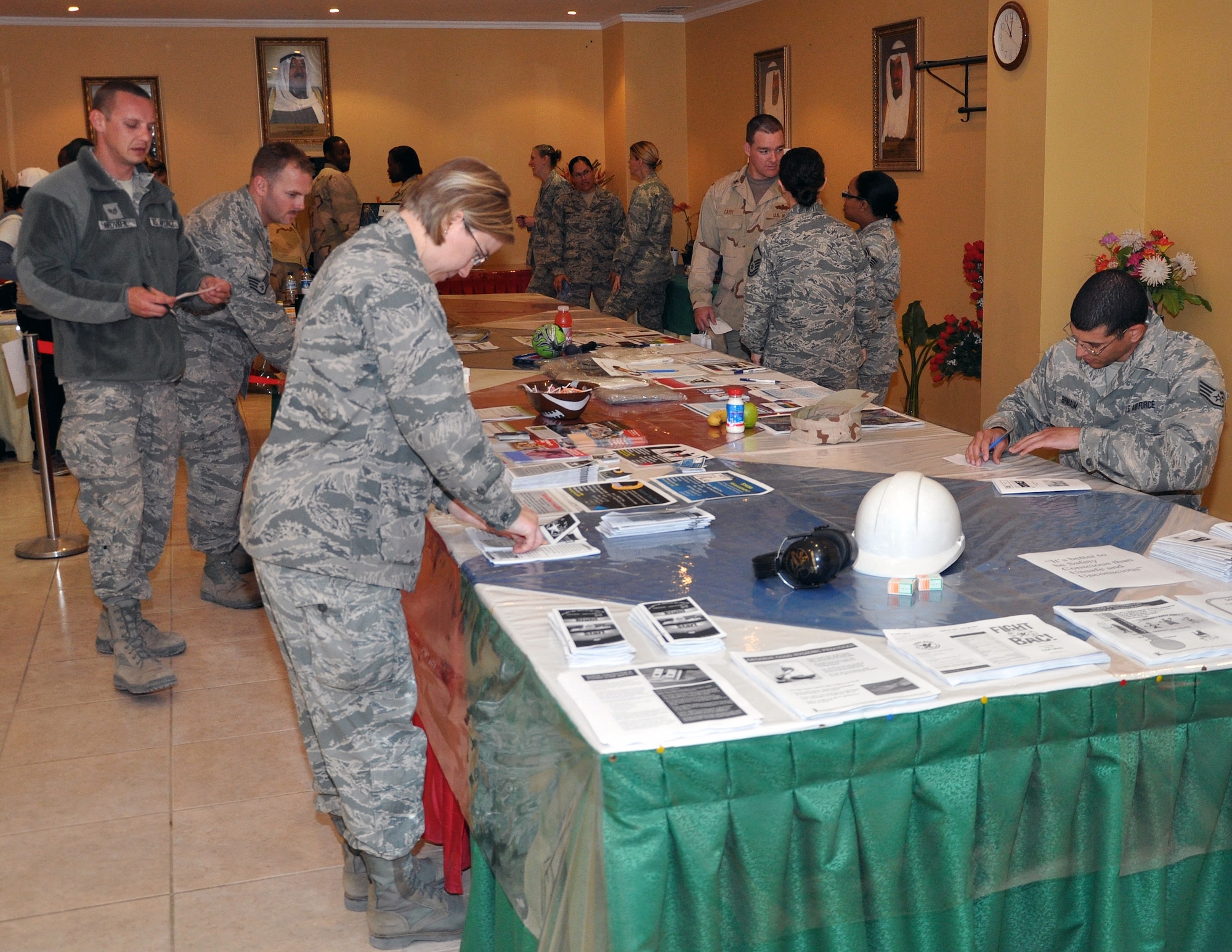 SOUTWEST ASIA -- Airmen with the 386th Air Expeditionary Wing check out the information and offerings from various on-base organizations during the Helping Agency Team (HAT) Care Fair in the Desert Winds Dining Facility at an undisclosed location, Southwest Asia, Feb. 9, 2012.  The HAT consists of the 386th AEW Chapel, 386th Expeditionary Force Support Squadron, Mental Health Clinic and more. Its main purpose is to support all deployed military members and civilians here, and the fair helps bring all these organizations into one place so it is easier for base personnel to get information and ask questions.  (U.S. Air Force photo/Tech. Sgt. Stacy Fowler)