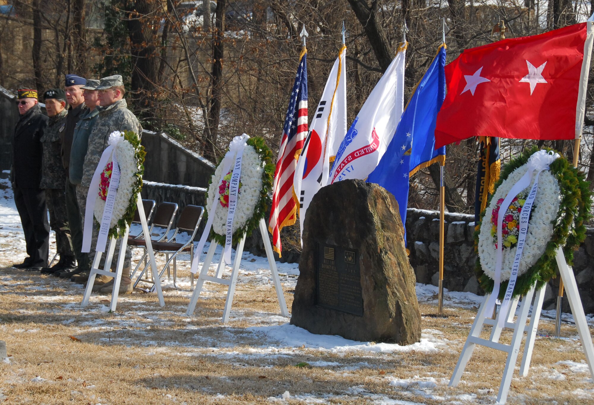 Team Osan paid tribute to the soldiers of the 27th Infantry Regiment, Feb. 3, 2012, whose heroic actions 61 years ago helped secure the freedom of South Koreans during the Korean War. Then Army Capt. Lewis Millett led Easy Company, from the 27th IR, toward Chinese and North Korean forces up a hill that later marks the location of Osan Air Base. (U.S. Air Force photo/Kyonghwan Song)
