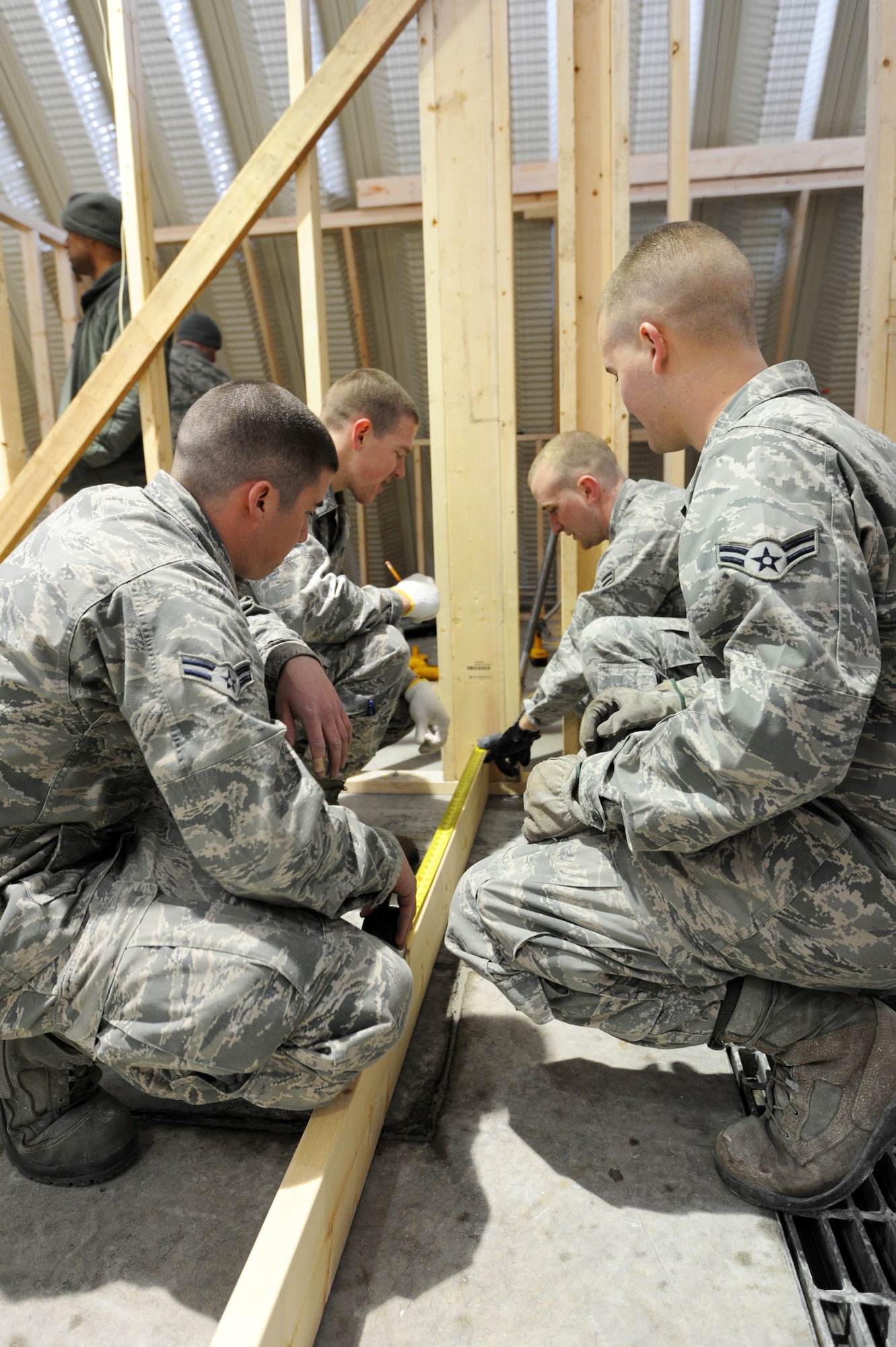 MISAWA AIR BASE, Japan -- From left, Airmen 1st Class Allen Broome, Derek Wagner, Evan Gustafson, and Cameron Holder, 35th Civil Engineer Squadron structural apprentices, measure lumber in Building 1366 here, Feb. 8. CES Airmen have been renovating the building, which will be the new location for a stray animal temporary care facility that will be operated by PAWS. PAWS has been operating within the Misawa community since the 1980's with the primary purpose of sheltering stray animals found on base. (U.S. Air Force photo/Airman 1st Class Kia Atkins)
