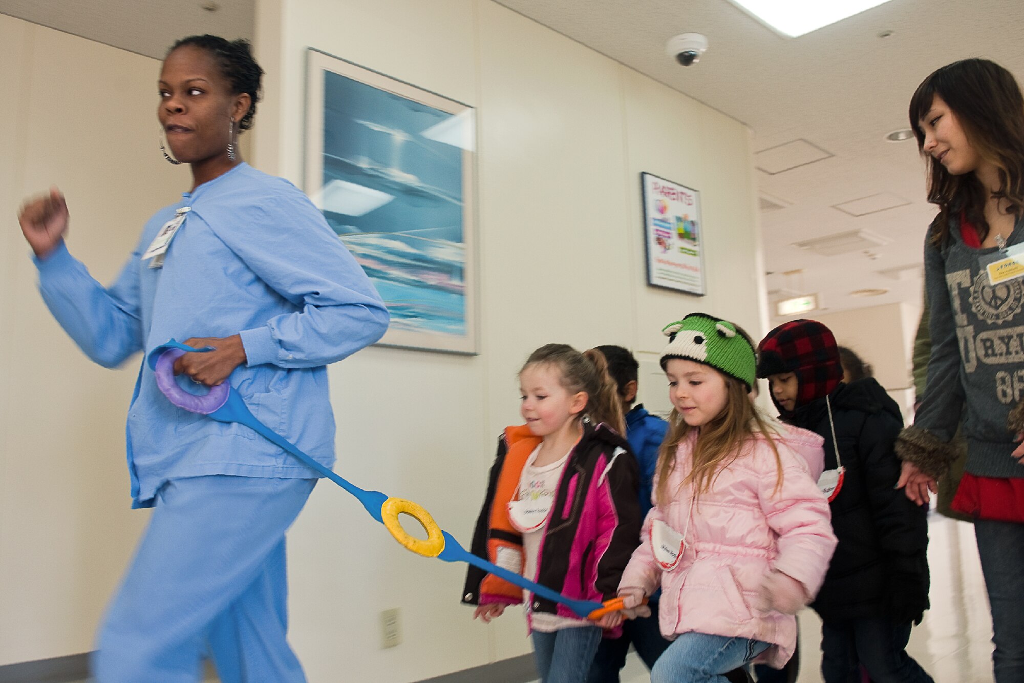 YOKOTA AIR BASE, Japan -- Tenika Davis, 374th Dental Squadron registered dental hygienist, leads children from Kibo Child Development Center, on a tour of the dental clinic at Yokota Air Base, Japan, Feb. 9, 2012. In celebration of National Children's Dental Health Month, which is the month of February, members from the 374th DS invite children for dental health class to increase their awareness of good oral health habits. (U.S. Air Force photo/Osakabe Yasuo)