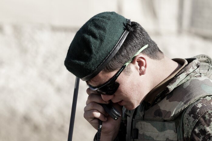 Afghan National Army Sgt. Shah Mohammed, a noncommissioned officer-in-charge with 3rd Tolai, 2nd Kandak, 2nd Brigade, 215th Corps, gives a report back to his commander during a security patrol here, Feb. 9. Afghan soldiers took over a local patrol base, Hanjar Yak, recently. They provide security for the local area by conducting patrols and maintaining positive relations with local villagers.