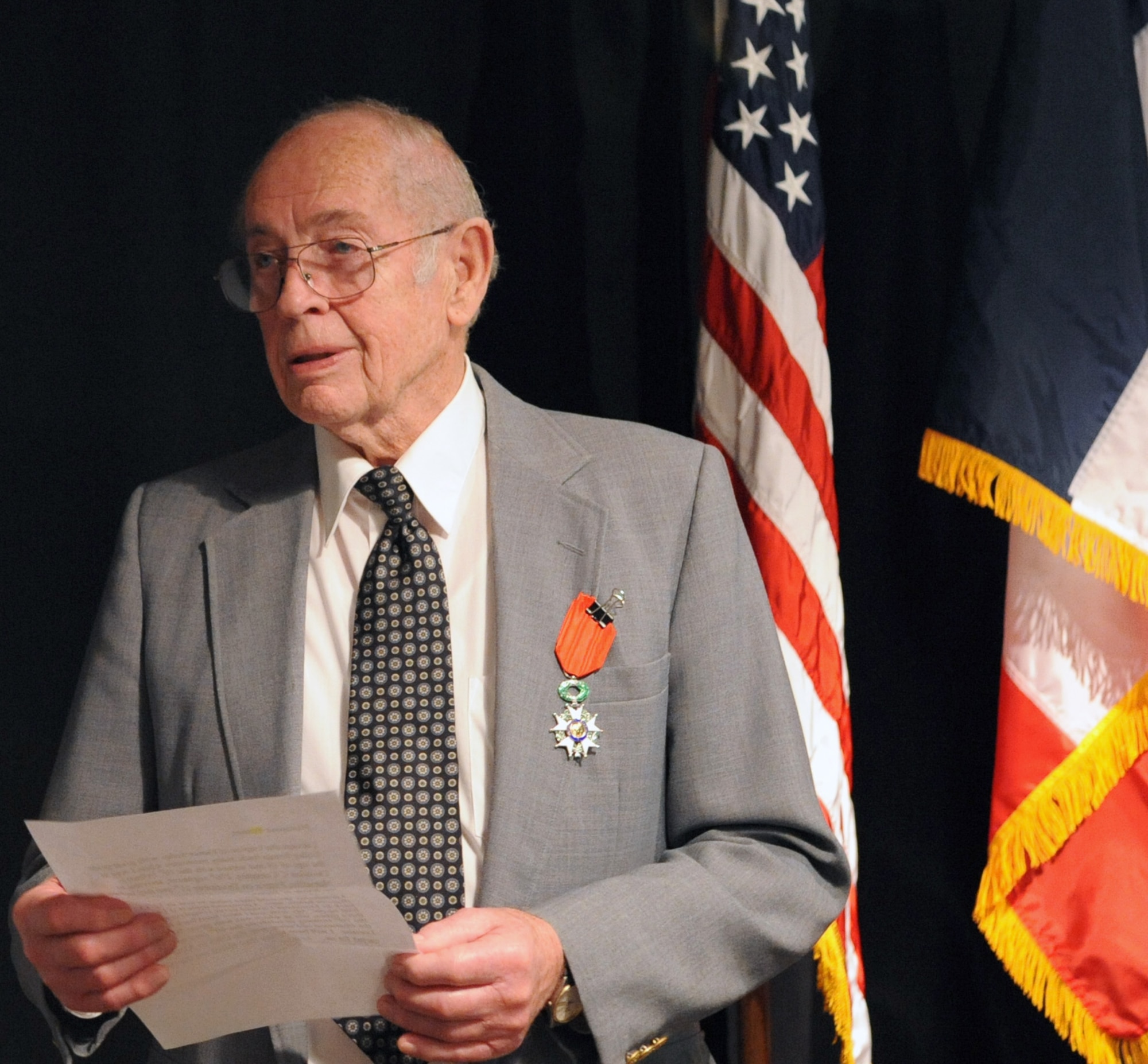 Mr. William V. Hines, World War II veteran reads his speech after receiving the distinction of the French Ordre national de la Légion d'honneur, or National Order of the Legion of Honor during a ceremony at Barksdale Air Force Base, La., Feb. 10. Mr. Hines was named French Knight in the order of the Legion of Honor by a decree signed by Nicolas Sarkozy, president of the French Republic. (U.S. Air Force photo/Senior Airman La'Shanette V. Garrett)(RELEASED)