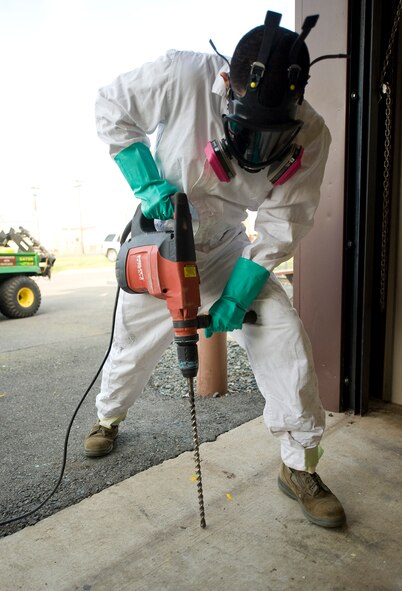 Senior Airman Jose Pinzon-Galarza, 2nd Civil Engineer Squadron Pest Management Flight, demonstrates how to use a drill on Barksdale Air Force Base, La., Feb. 9. In order to deposit pesticides under a building, pest management Airmen must drill through the foundation to the soil below. (U.S. Air Force photo/Senior Airman Chad Warren)(RELEASED)