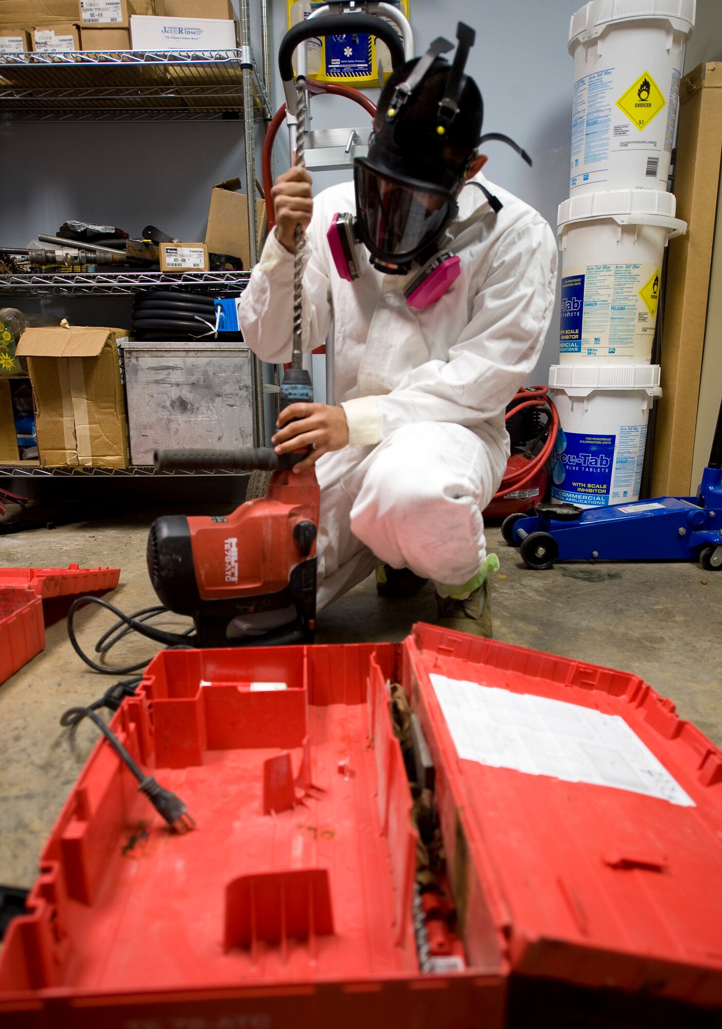 Senior Airman Jose Pinzon-Galarza, 2nd Civil Engineer Squadron Pest Management Flight, assembles a drill on Barksdale Air Force Base, La., Feb. 9. In order to deposit pesticides under a building, pest management Airmen must drill through the foundation to the soil below. (U.S. Air Force photo/Senior Airman Chad Warren)(RELEASED)