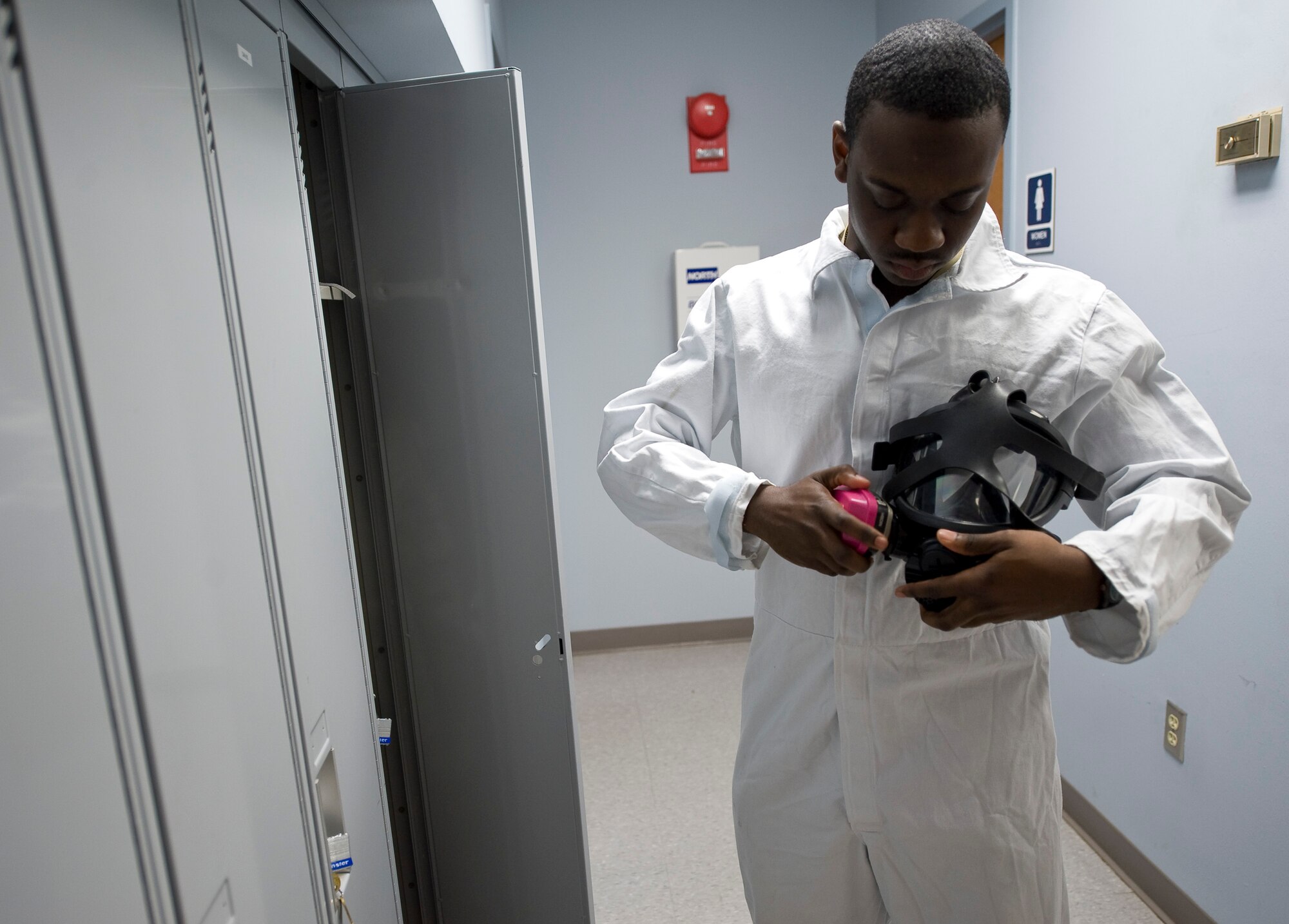 Senior Airman Thomas Davis, 2nd Civil Engineer Squadron Pest Management Flight, prepares his mask on Barksdale Air Force Base, La., Feb. 9. The mask is one piece of the protective equipment worn by Airmen when handling pesticides. (U.S. Air Force photo/Senior Airman Chad Warren)(RELEASED)