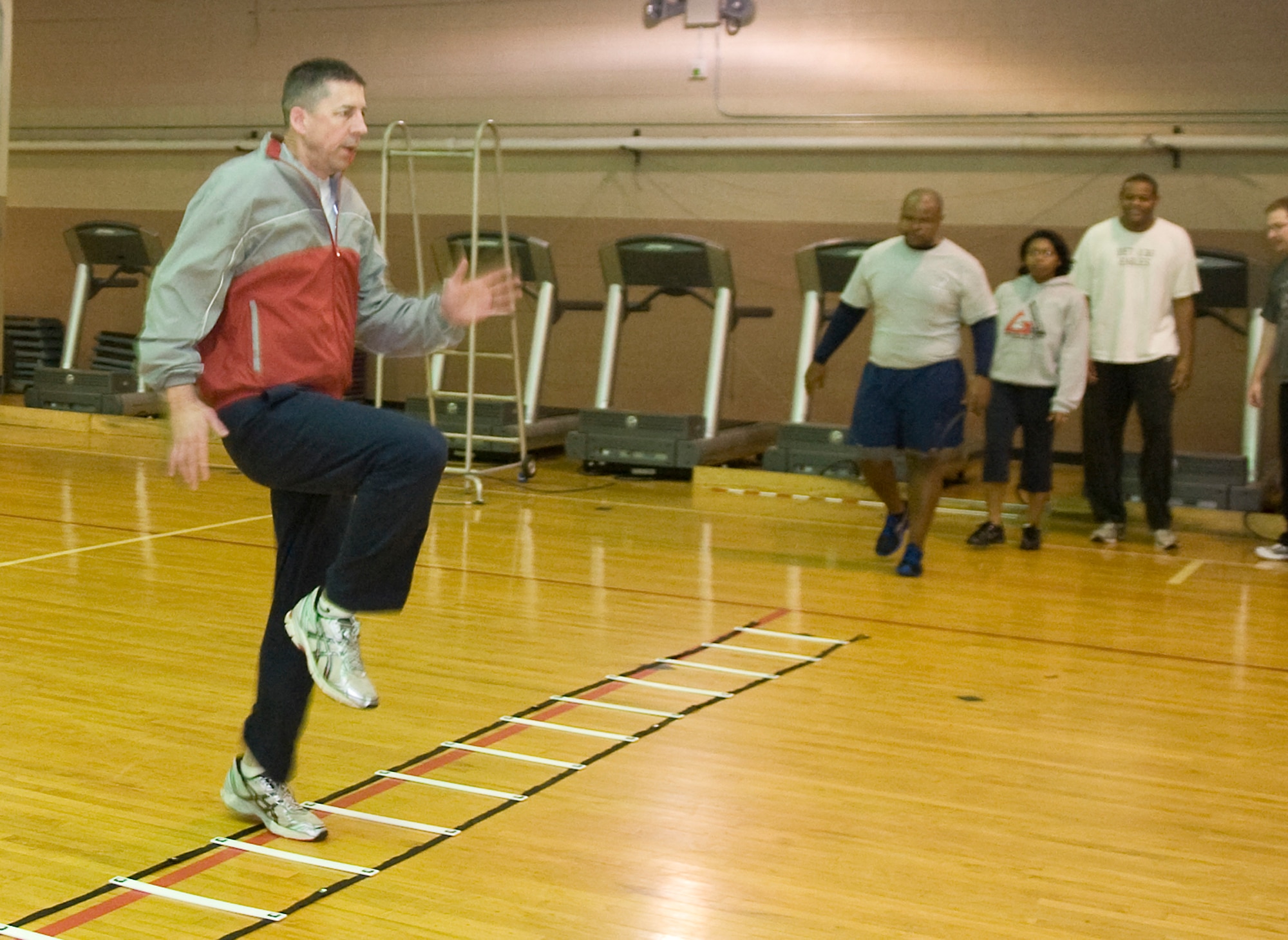 Maj. James Stigers, 2nd Aerospace Medicine, performs lateral high knees on an agility ladder during the Run Improvement Program workout on Barksdale Air Force Base, La., Feb. 10. RIP, developed by Leah Beckham, 2nd Medical Operations Squadron Health and Wellness Center health and fitness specialist, is a 4-week class filled with personalized attention on form, strength and endurance to help improve overall fitness of Team Barksdale members. (U.S. Air Force photo/Senior Airman Kristin High)(RELEASED)
