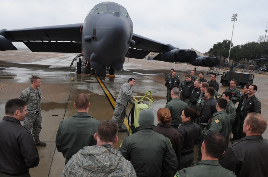 Senior Airman Gregory Ward, 2nd Aircraft Maintenance Squadron teaches aircrew from the 96th Bomb Squadron how to operate a fire extinguisher on Barksdale Air Force Base, La., Feb. 10. The flight crews toured the B-52H Stratofortress to learn how to perform basic maintenance on the aircraft in the event they land in a location without any maintainers. (U.S. Air Force photo/Airman 1st Class Micaiah Anthony)(RELEASED)