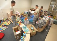 Left to right, Airmen Basic Daniel Arsyle, Thomas Hylton, Chase Gleaton, and Joseph Kain, and Airman 1st Class Sean McGinnnis, technical school students with the 342nd Training Squadron, move toys and assemble furniture at the new Lackland Child Development Center Jan. 18. The facility is tentatively scheduled to open in late February. (U.S. Air Force photo/Robbin Cresswell)