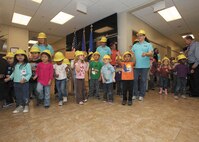 Lackland Child Development Center staff and children perform “Johnny Hammers with One Hammer” at the Jan. 24 ribbon-cutting ceremony marking the upcoming opening of the facility’s new addition later this month (U.S. Air Force photo/Robbin Cresswell)