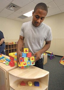 Airman 1st Class Demadra Humphrey, 59th Medical Logistics Readiness Squadron, unpacks toys at the Lackland Child Development Center. Volunteers from various base organizations helped prepare the CDC for the opening of its new addition later this month. (U.S. Air Force photo/Robbin Cresswell)