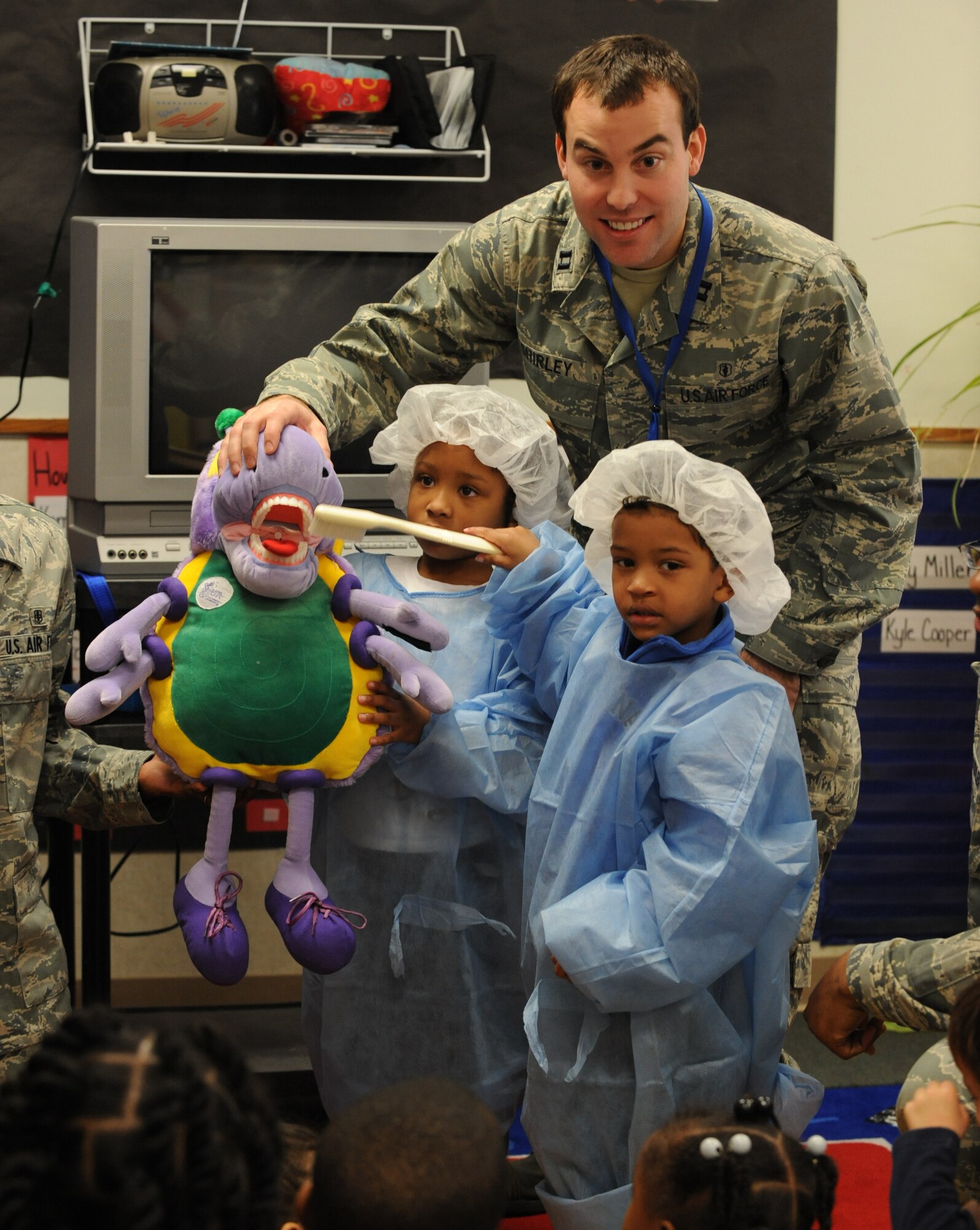 Capt. James Shirley, 2nd Dental Squadron, shows children from the Child Development Center how to brush their teeth at Barksdale Air Force Base, La., Feb. 7. National Children's Dental Health Month was created by the American Dental Association to help children develop dental hygiene habits at an early age. (U.S. Air Force photo/Airman 1st Class Micaiah Anthony)(RELEASED