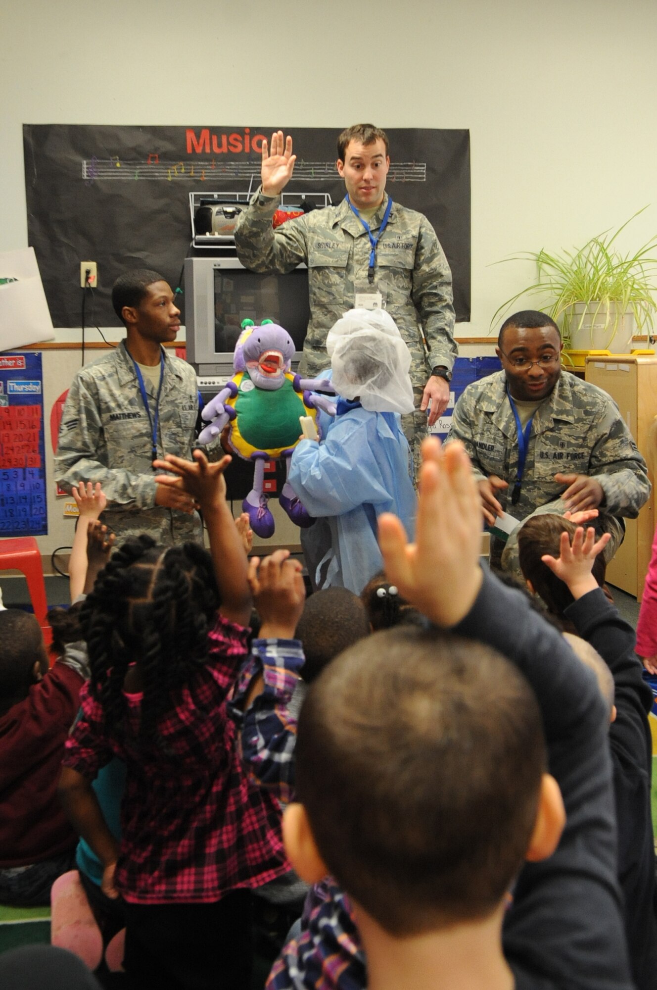 Capt. James Shirley, 2nd Dental Squadron, ask 3-to-5 year old children at the Child Development Center about how to brush their teeth at Barksdale Air Force Base, La., Feb. 7. Shirley and other 2 DS members visited the CDC as a part of National Children's Dental Health Month. (U.S. Air Force photo/Airman 1st Class Micaiah Anthony)(RELEASED)