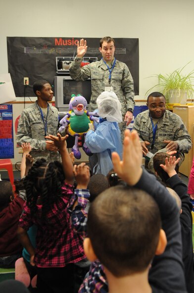 Capt. James Shirley, 2nd Dental Squadron, ask 3-to-5 year old children at the Child Development Center about how to brush their teeth at Barksdale Air Force Base, La., Feb. 7. Shirley and other 2 DS members visited the CDC as a part of National Children's Dental Health Month. (U.S. Air Force photo/Airman 1st Class Micaiah Anthony)(RELEASED)
