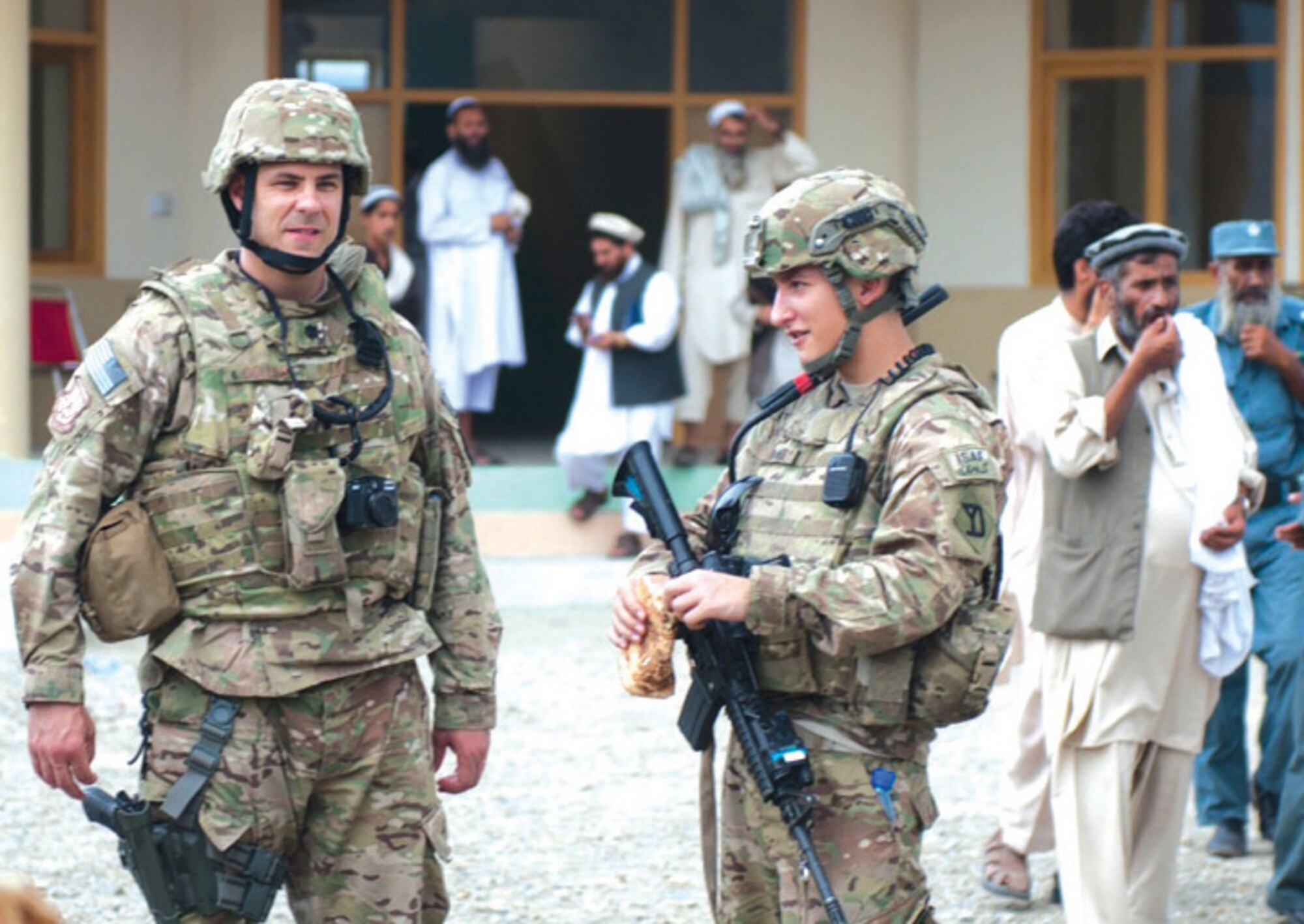 Lt. Col. Jeffrey Collins, left, an assistant professor in the English and Fine Arts Department, attends a Provincial Reconstruction Team opening of a boys’ school in Konar Province, Afghanistan. (U.S. Air Force Photo)