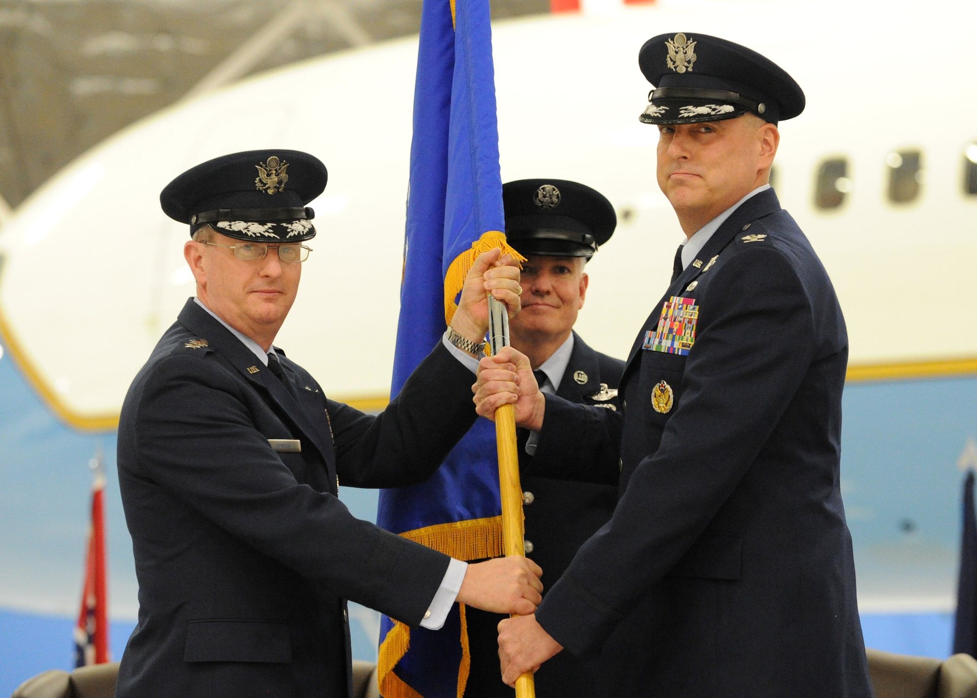 JOINT BASE ANDREWS, Md. -- Lt. Gen. Mark Ramsay, 18th Air Force commander, passes the 89th Airlift Wing guidon to incoming commander Col. Mike Minihan during a Change of Command ceremony here Feb. 10. The Change of Command ceremony marks a formal passing of responsibility, authority, and accountability of command from one leader to another. (U.S. Air Force photo/ Staff Sgt. Nichelle Anderson)