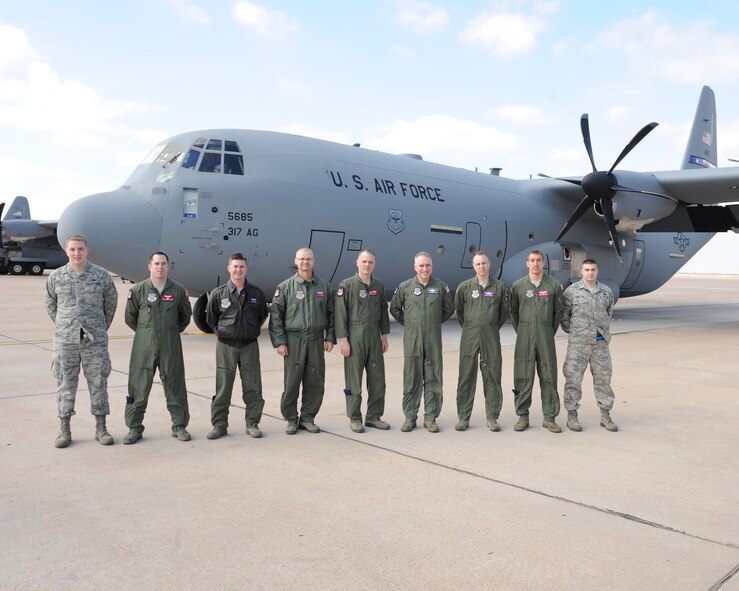 The crew of a new C-130 J-model gathers outside the aircraft Feb. 9, 2012, at Dyess Air Force Base, Texas. The aircraft is 14th of 28 J-models to be delivered to Dyess by 2013 and the first for the 39th Airlift Squadron. (U.S. Air Force photo by Airman 1st Class Peter Thompson/Released)