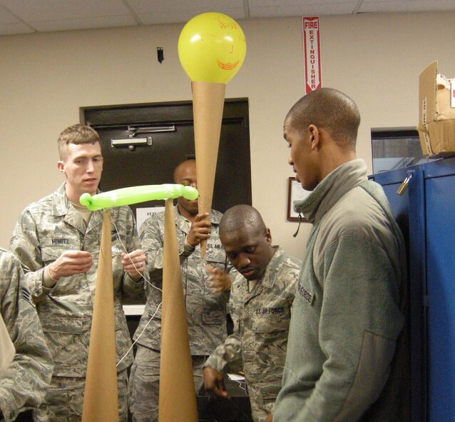 Airmen from the 916th Aircraft Maintenance Propulsion Flight work together as part of a Wingman Day scenario to complete a cone tower during the February drill weekend. (USAF photo courtesy of 916MXS)