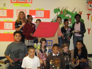 Christian Leonard-Brown, center, a third grade student at General Stanford Elementary School, poses with his classmates in front of the display they created to collect shoes for children in the earthquake-devastated country of Haiti. Christian will be making a trip to Haiti this March to personally deliver the shoes. (Courtesy photo)