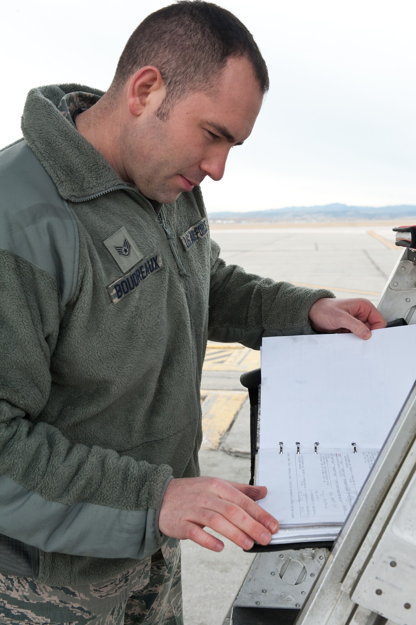 Staff Sgt. Ryan Boudreaux, 28th Maintenance Group quality assurance inspector, reviews maintenance records on a B-1B during a quality assurance inspection at Ellsworth Air Force Base, S.D., Feb. 2, 2012. These records provide information about the aircraft’s and allows maintenance history quality assurance inspectors to indentify each task performed along with the responding responsible technician. (U.S. Air Force photo by Airman Alystria Maurer/Released)