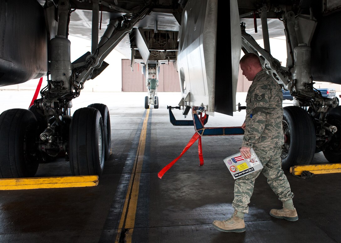 Staff Sgt. Ryan Walker, 28th Maintenance Group quality assurance inspector, performs a walk-around inspection on a B-1B at Ellsworth Air Force Base, S.D., Feb. 2, 2012. All operations on the flightline are monitored by quality assurance inspectors to ensure maintenance and support personnel complete their tasks safely and properly. (U.S. Air Force photo by Airman Alystria Maurer/Released)