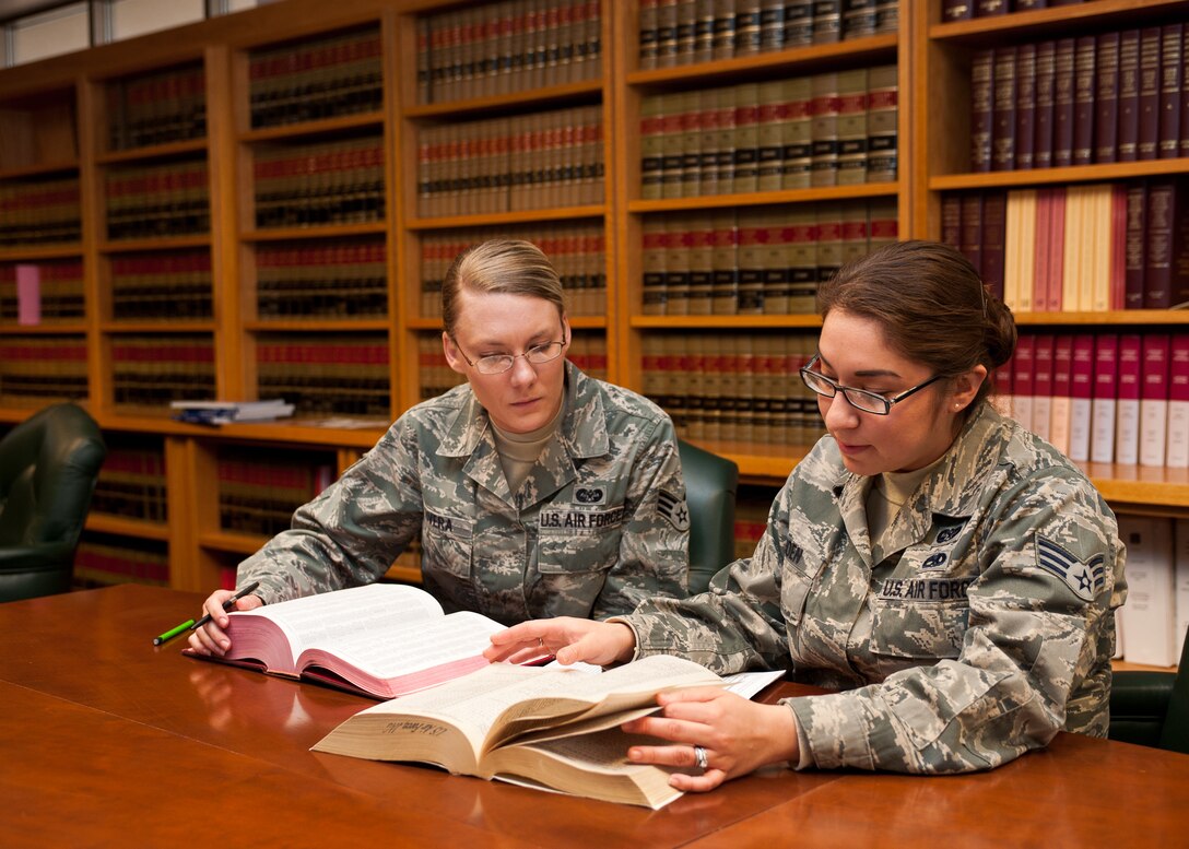 Senior Airman Alexandra Rivera, 28th Bomb Wing general law paralegal, and Senior Airman Erica Thoen, 28th Bomb Wing military justice paralegal, research codes and laws for a case on Ellsworth Air Force Base, S.D., Jan. 26, 2012. The legal office provides legal support to the command and deals with many facets of profession, including environmental, contract, and labor operation law. (U.S. Air Force photo by Airman Alystria Maurer/Released)