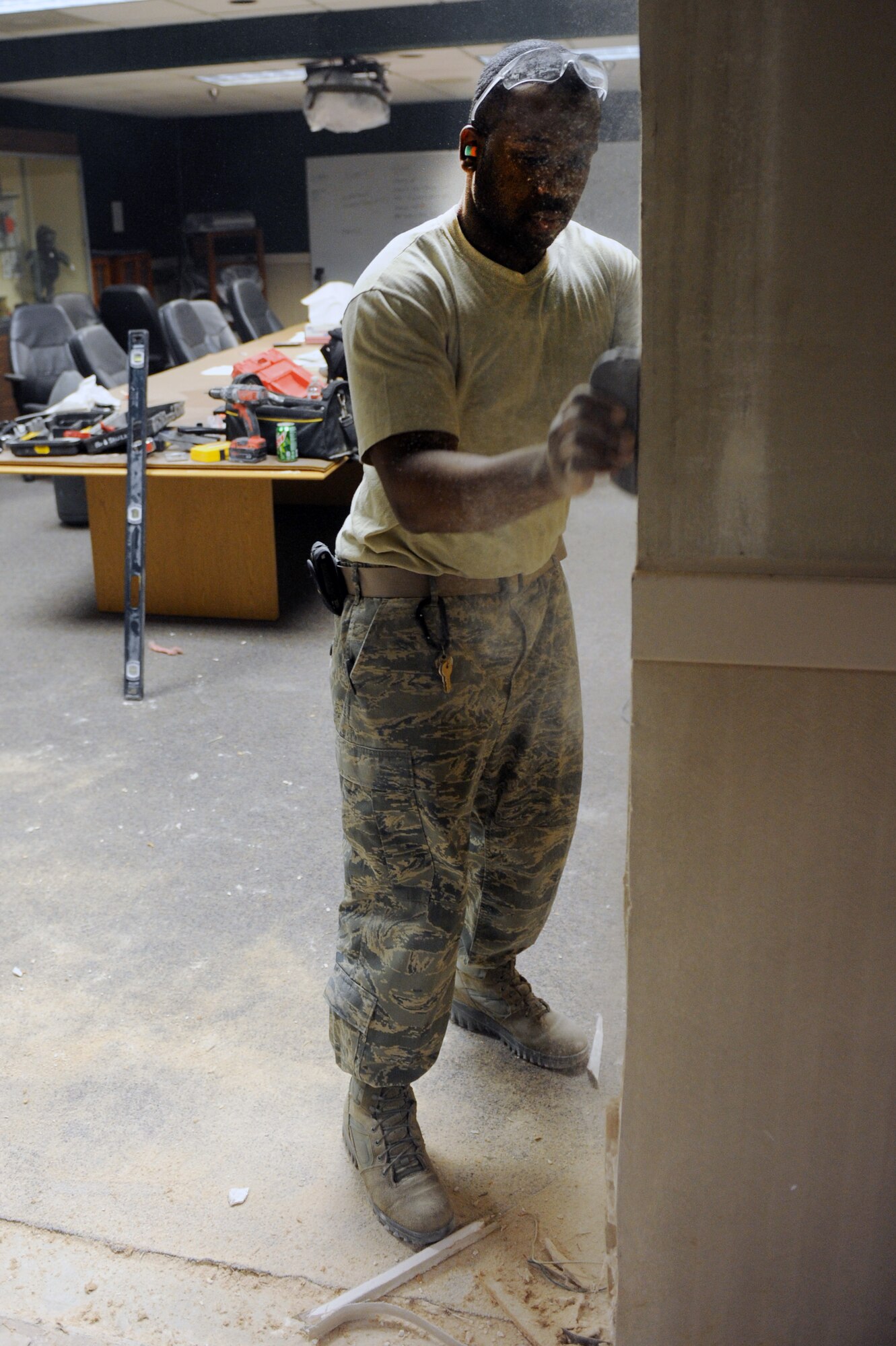 Senior Airman Chris Norwood, a 19th Civil Engineer Squadron structures journeyman, uses a rasp to level the edges of a wall, Feb. 6, 2012, at Little Rock Air Force Base, Ark. The 19th CES ensures access for a global airlift mission by acquiring and improving facilities and the environment, preparing to respond in war and peace, and deploying mission ready war fighters. (U.S. Air Force Photo by Airman 1st Class Rusty Frank)