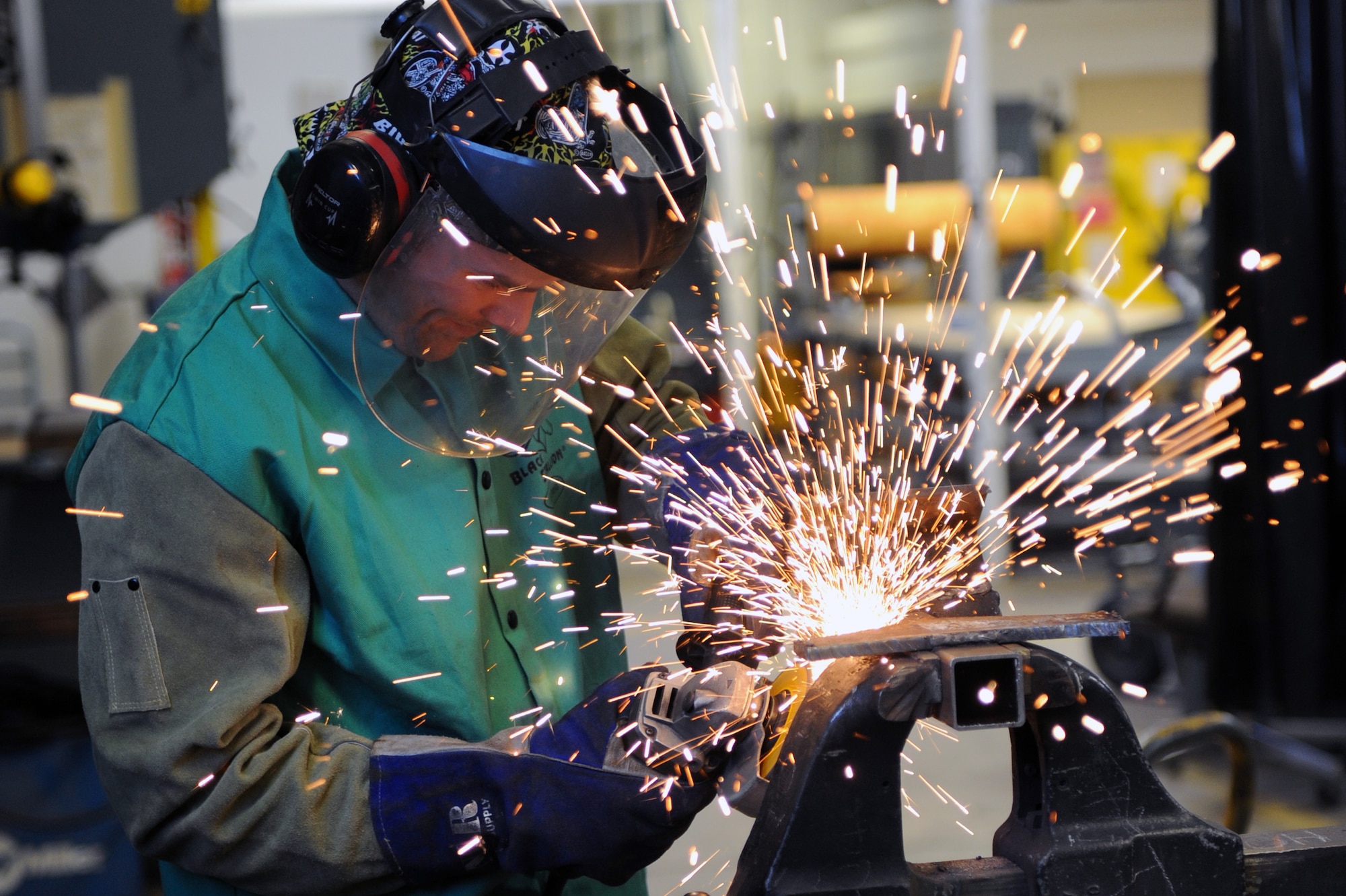 Airman 1st Class Philip Madden, a 19th Civil Engineer Squadron structures apprentice, grinds the edges of a piece of quarter inch metal Feb. 2, 2012, at Little Rock Air Force Base, Ark. Madden grinds the edges down to ensure that they are smooth, so they don’t cause injury to people. (U.S. Air Force Photo by Airman 1st Class Rusty Frank)