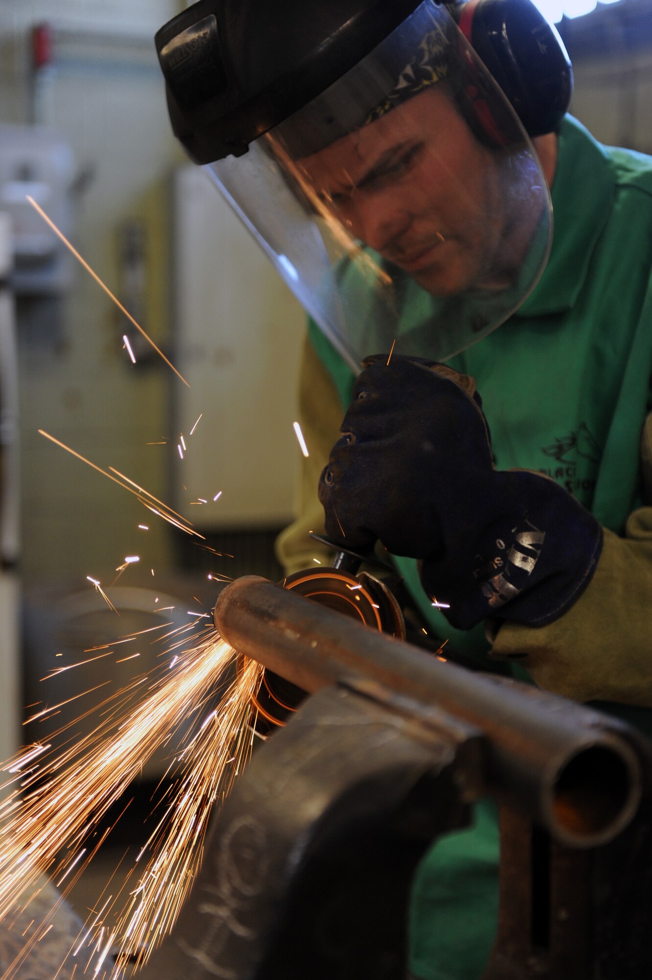 Airman 1st Class Philip Madden, a 19th Civil Engineer Squadron structures apprentice, grinds the edges of a piece of quarter inch metal Feb. 2, 2012, at Little Rock Air Force Base, Ark. Madden grinds the edges down to ensure that they are smooth, so they don’t cause injury to people. (U.S. Air Force Photo by Airman 1st Class Rusty Frank)