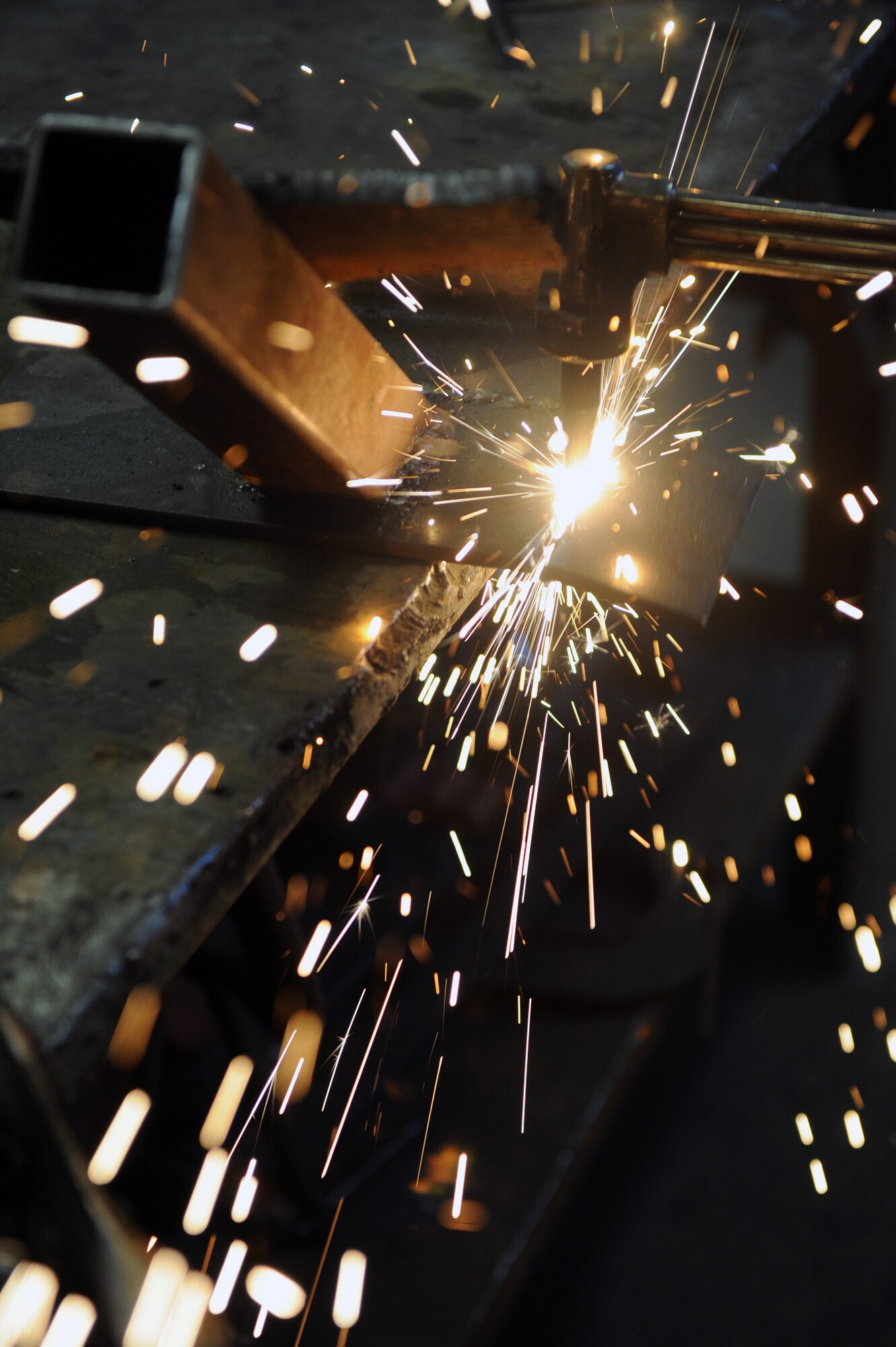 Airman 1st Class Philip Madden, a 19th Civil Engineer Squadron structures apprentice, uses a plasma cutter to cut the edges off a quarter inch metal Feb. 2, 2012, at Little Rock Air Force Base, Ark. The 19th CES provides global combat support using transformational business practices and innovative technologies supporting combatant commanders. (U.S. Air Force Photo by Airman 1st Class Rusty Frank)