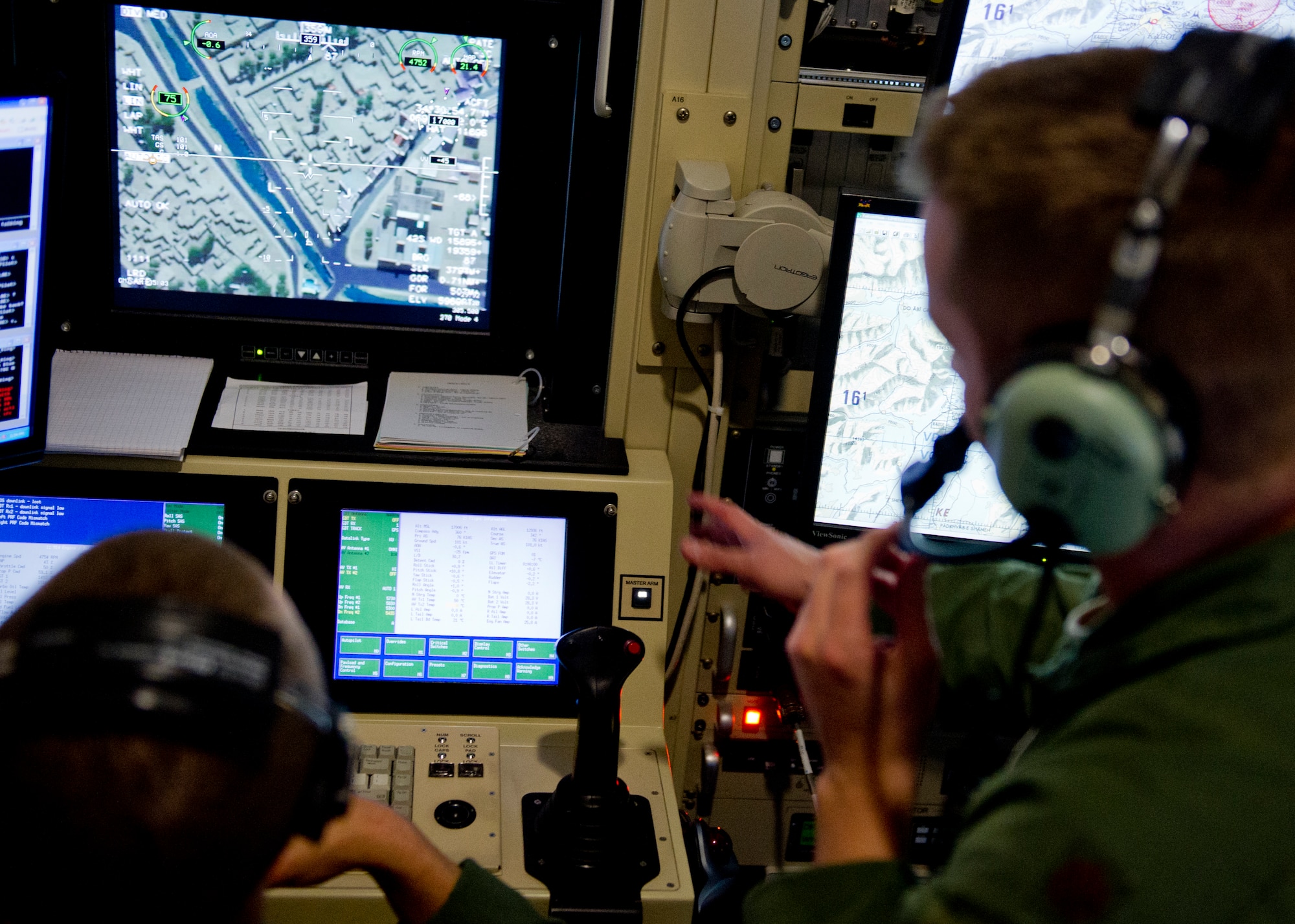 HOLLOMAN AIR FORCE BASE, N.M.—A U.S. Air Force major instructs 2nd Lt. Zachary, an 18X student, during a training mission in an MQ-1 simulator Feb. 8. Remotely Piloted Aircraft pilots from across the Air Force have come to Holloman to teach the students in this new career field, which allows officers to become RPA pilots without attending traditional undergraduate pilot training. According to current Air Force guidance, the last names of RPA pilots and sensor operators are not releasable due to operational security constraints. (U.S. Air Force photo by 2nd Lt. Logan Clark/Released) 