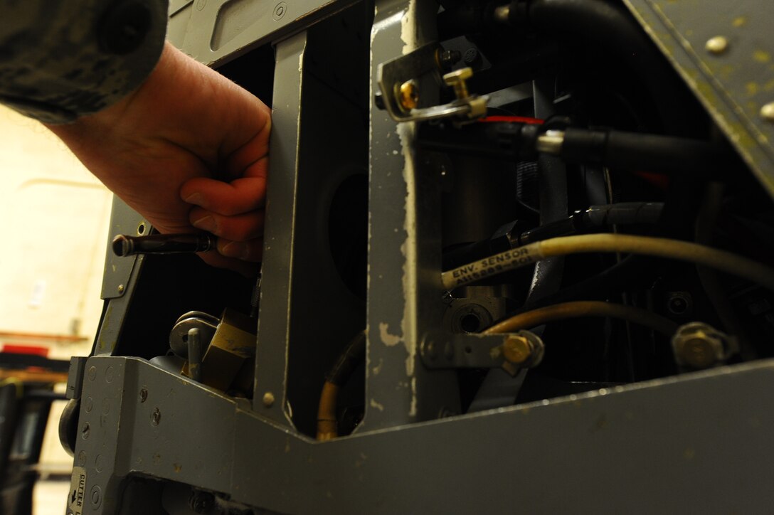Airman Calvin Daniels, 28th Maintenance Squadron aircrew egress system apprentice, performs adjustments on the drogue gun on an Advance Concept Ejection Seat II during a training session at Ellsworth Air Force Base, S.D., Jan. 23, 2012. The drogue gun uses a cartridge to propel a 1.2 pound slug into the airstream to deploy the drogue and extraction chute to stabilize the ACES II after an ejection. (U.S. Air Force photo by Airman 1st Class Zachary Hada/Released)