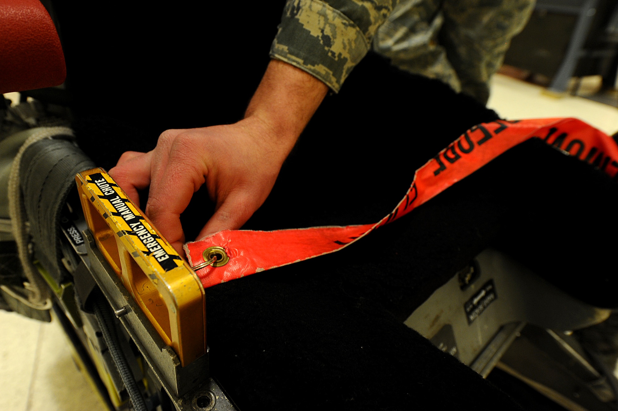 Airman Calvin Daniels, 28th Maintenance Squadron aircrew egress system apprentice, installs a  safety pin into an Advance Concept Ejection Seat during a training session at Ellsworth Air Force Base, S.D., Jan. 23, 2012. Safety pins are installed into ejector seats to prevent accidental ejections by air and ground crews during maintenance operations. (U.S. Air Force photo by Airman 1st Class Zachary Hada/Released)
