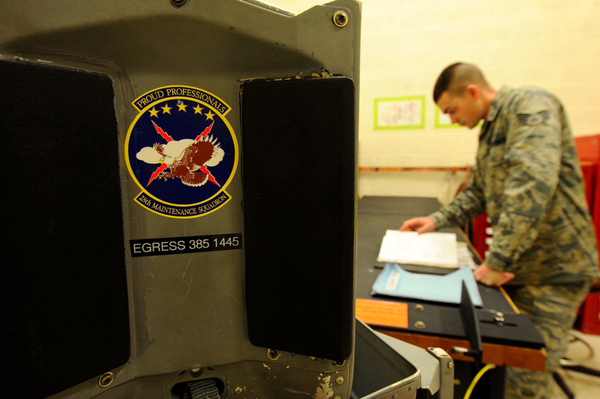 Senior Airman Timothy Milders, 28th Maintenance Squadron aircrew egress system journeyman, looks through a technical order on an Advanced Concept Ejection Seat II during training at Ellsworth Air Force Base, S.D., Jan. 23, 2012. Egress Airmen perform daily checks on procedures to ensure standards for safety are maintained. (U.S. Air Force photo by Airman 1st Class Zachary Hada/Released)