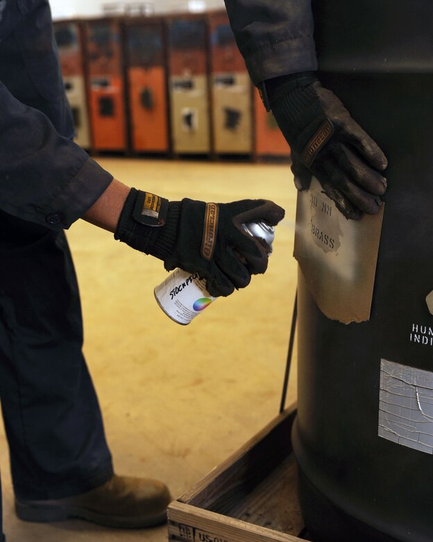 U.S. Air Force Airman 1st Class Moses Grier, 355th Equipment Maintenance Squadron, spray paints 30mm on barrels on Davis-Monthan Air Force Base, Ariz., Feb. 8, 2012. (U.S. Air Force photo by Airman 1st Class Christine Griffiths/Released) 