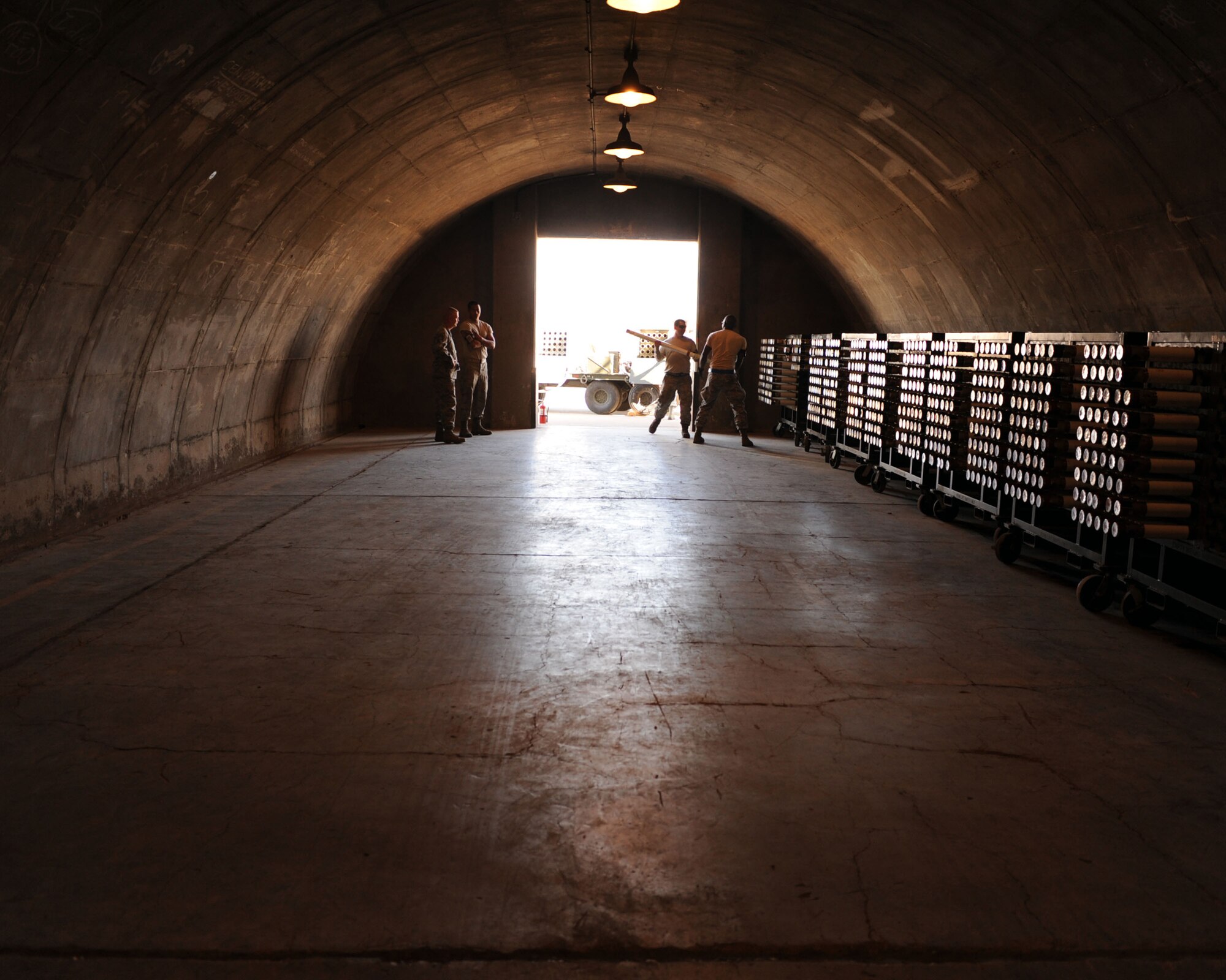 U.S. Air Force Airmen store ammunition on Davis-Monthan Air Force Base, Ariz., Feb. 7, 2012. Ammunition is stored in a building made a concrete with two feet of grass or dirt above. This contains any effects of an internal explosion. (U.S. Air Force photo by Airman 1st Class Christine Griffiths/Released)
