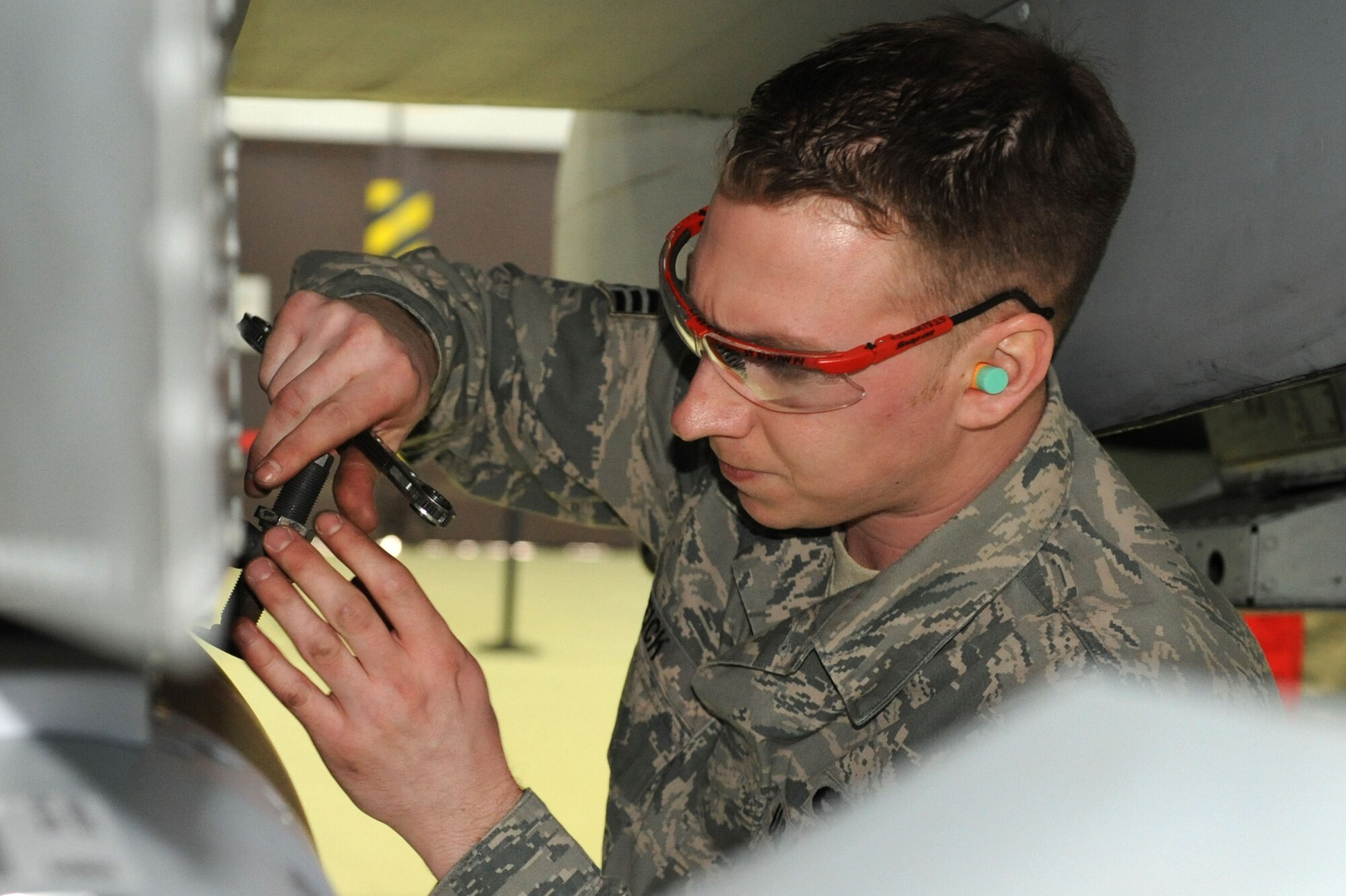 SPANGDAHLEM AIR BASE, Germany – Senior Airman Robert Weick, 81st Aircraft Maintenance Unit weapon load crew member, secures a GBU-38 bomb to a A-10 Thunderbolt II during the load crew of the year competition at Hangar 1 here Feb. 10. Each of the three load crews won a quarterly competition to participate in this event.  The winner will be announced at the wing annual awards March 9 and will represent Spangdahlem AB in a U.S. Air Forces in Europe load crew competition later this year. The 81st and 480th AMUs maintain aircraft that deliver precise, full-spectrum capability for the current fight. (U.S. Air Force photo by Senior Airman Christopher Toon/Released)
