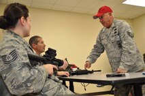 Tech. Sgt. Thomas Welch (right) teaches his last class as combat arms instructor in December 2011. Welch retired in February 2012 with 20 years of service. (USAF MSgt. Wendy Lopedote, 916ARW/PA)