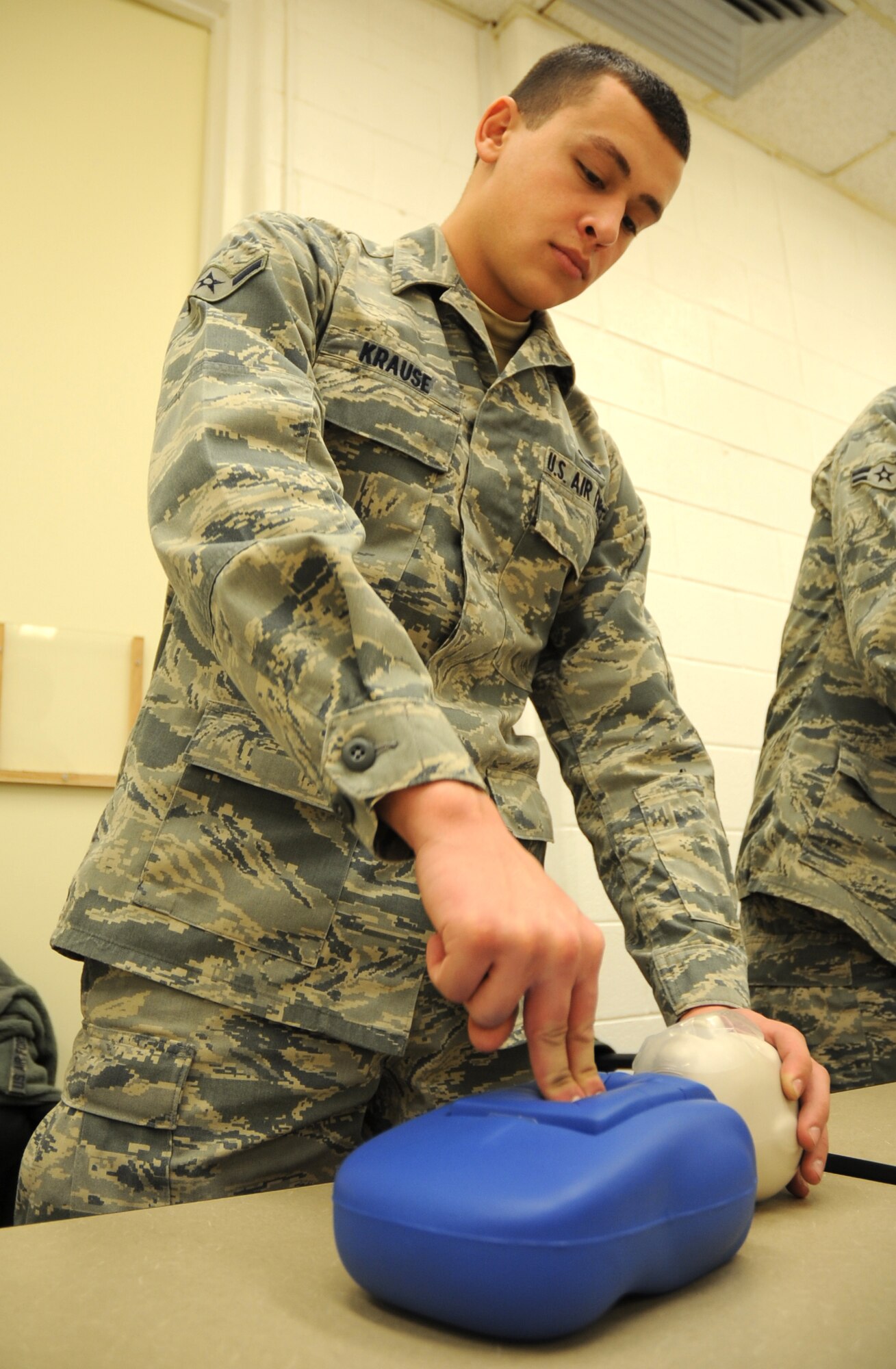 U.S. Air Force Airman Eric Krause, 27th Special Operations Equipment Maintenance Squadron, practices infant chest compressions on his CPR dummy in a training detachment at Cannon Air Force Base, N.M., Feb. 8, 2012. The CPR course provided is through the American Heart Association and is required by the 27th Special Operations Maintenance Group every two years. (U.S. Air Force photo by Airman 1st Class Alexxis Pons Abascal) 