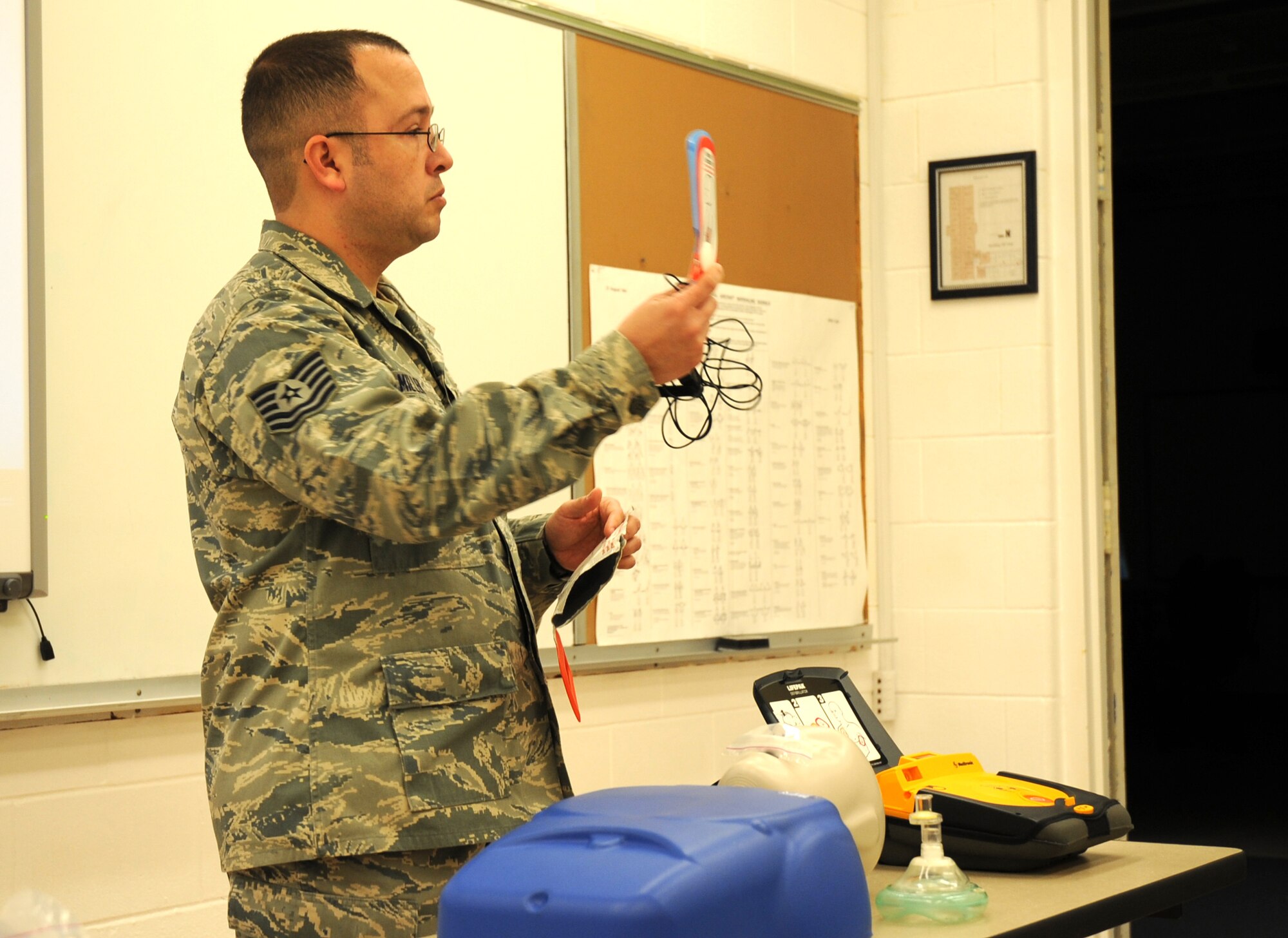 U.S. Air Force Tech. Sgt. Jason Miller, 27th Special Operations Maintenance Operations Squadron, explains components of an Automated External Defibrillator to his class in a training detachment at Cannon Air Force Base, N.M., Feb. 8, 2012. The CPR course provided is through the American Heart Association and is required by the 27th Special Operations Maintenance Group every two years. (U.S. Air Force photo by Airman 1st Class Alexxis Pons Abascal) 