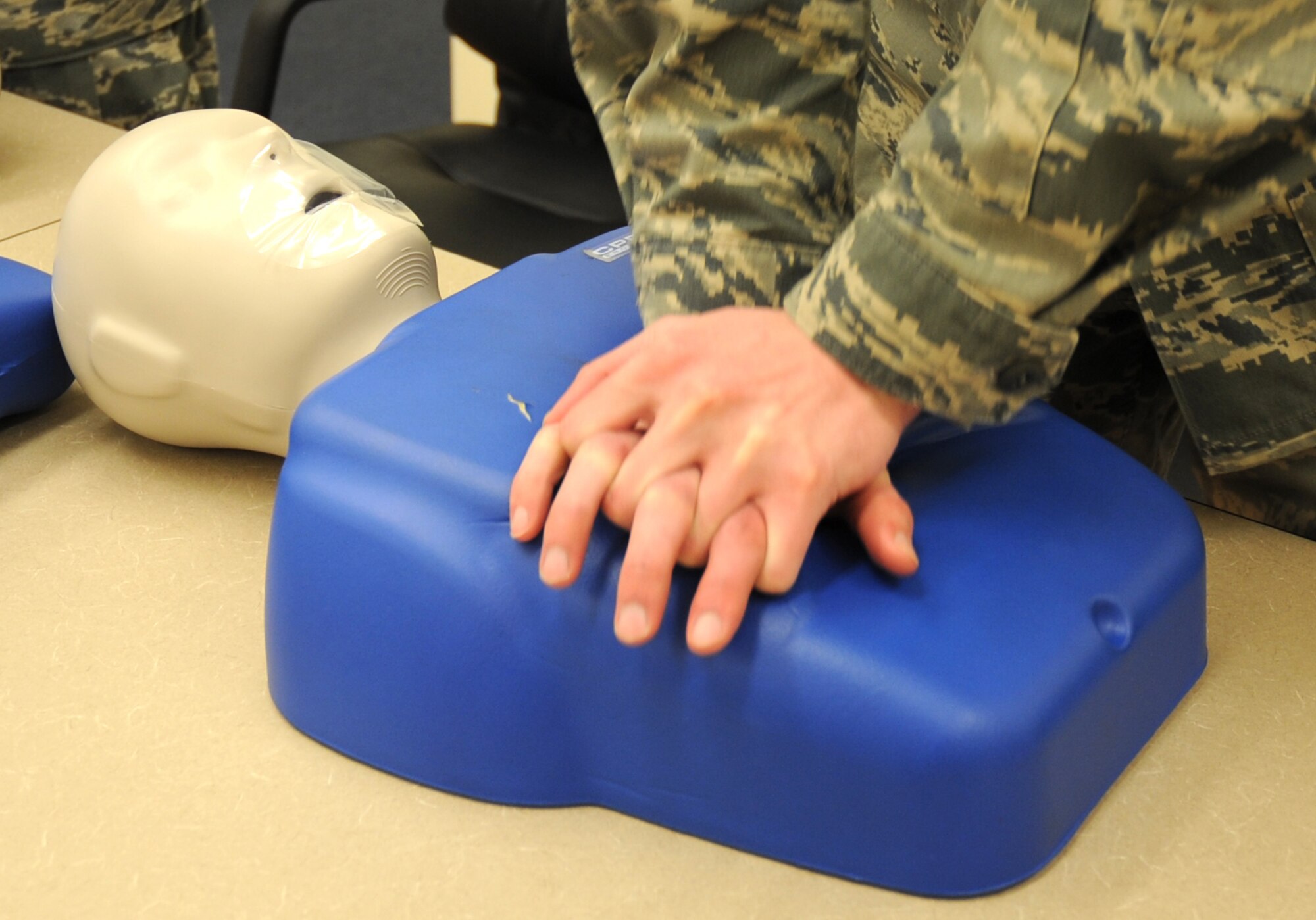 U.S. Air Force Airman 1st Class Jason Brooks, 27th Special Operations Equipment Maintenance Squadron, practices chest compressions on his CPR dummy in a training detachment at Cannon Air Force Base, N.M., Feb. 8, 2012. The CPR course provided is through the American Heart Association and is required by the 27th Special Operations Maintenance Group every two years. (U.S. Air Force photo by Airman 1st Class Alexxis Pons Abascal) 