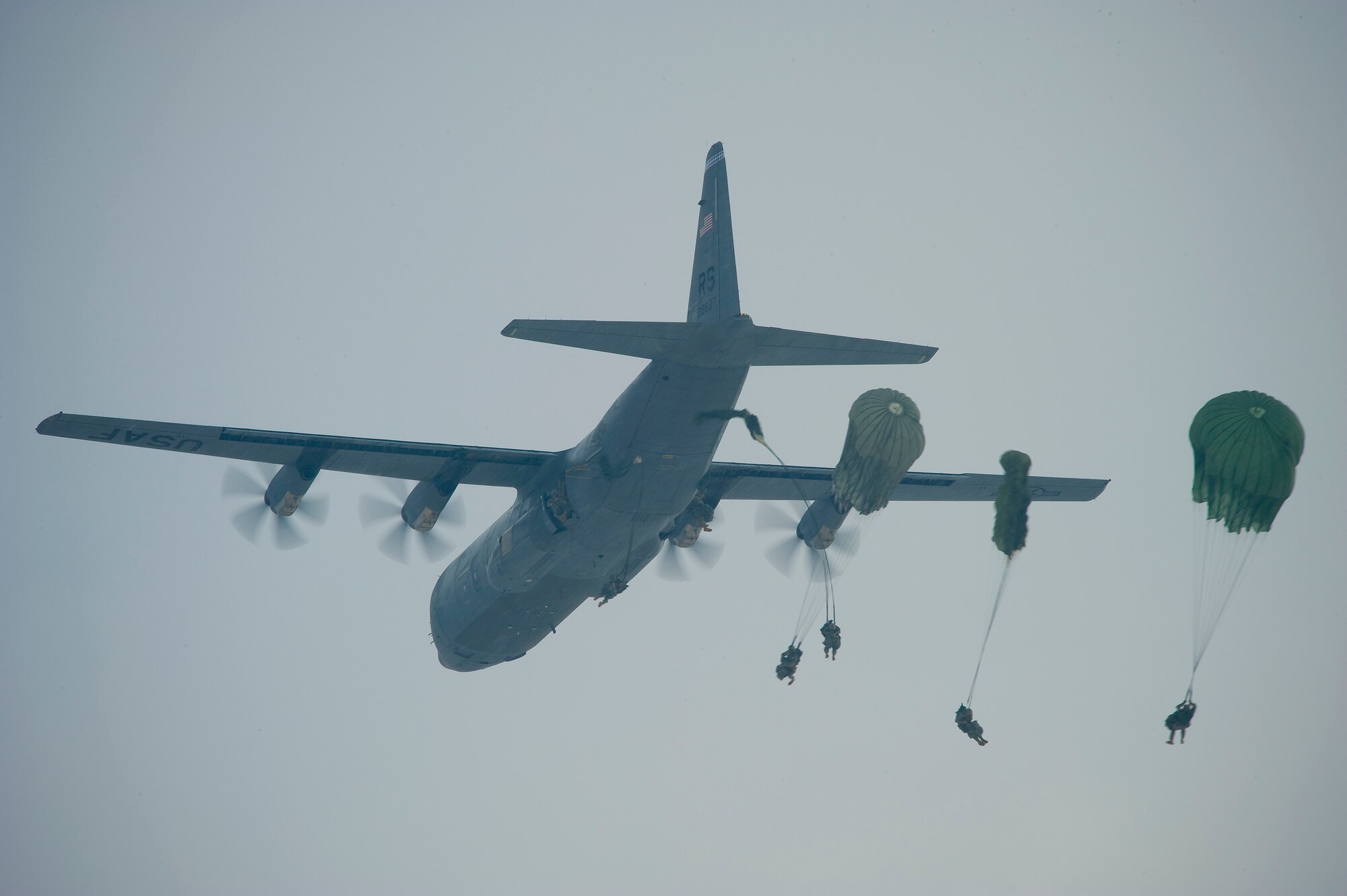 A U.S. Air Force C-130J Super Hercules assigned to the 37th Airlift Squadron, Ramstein Air Base, Germany, conducts a mass airdrop of paratroopers from the U.S. Army's 173rd Airborne Brigade Combat Team, out of Aviano Air Base, Italy, Feb. 10, 2012. The mass airdrop over Alzey, Germany, commemorated 70 years of combat airlift capabilities for the 37th AS. (U.S. Air Force photo by Senior Amn. Stephen J. Otero)