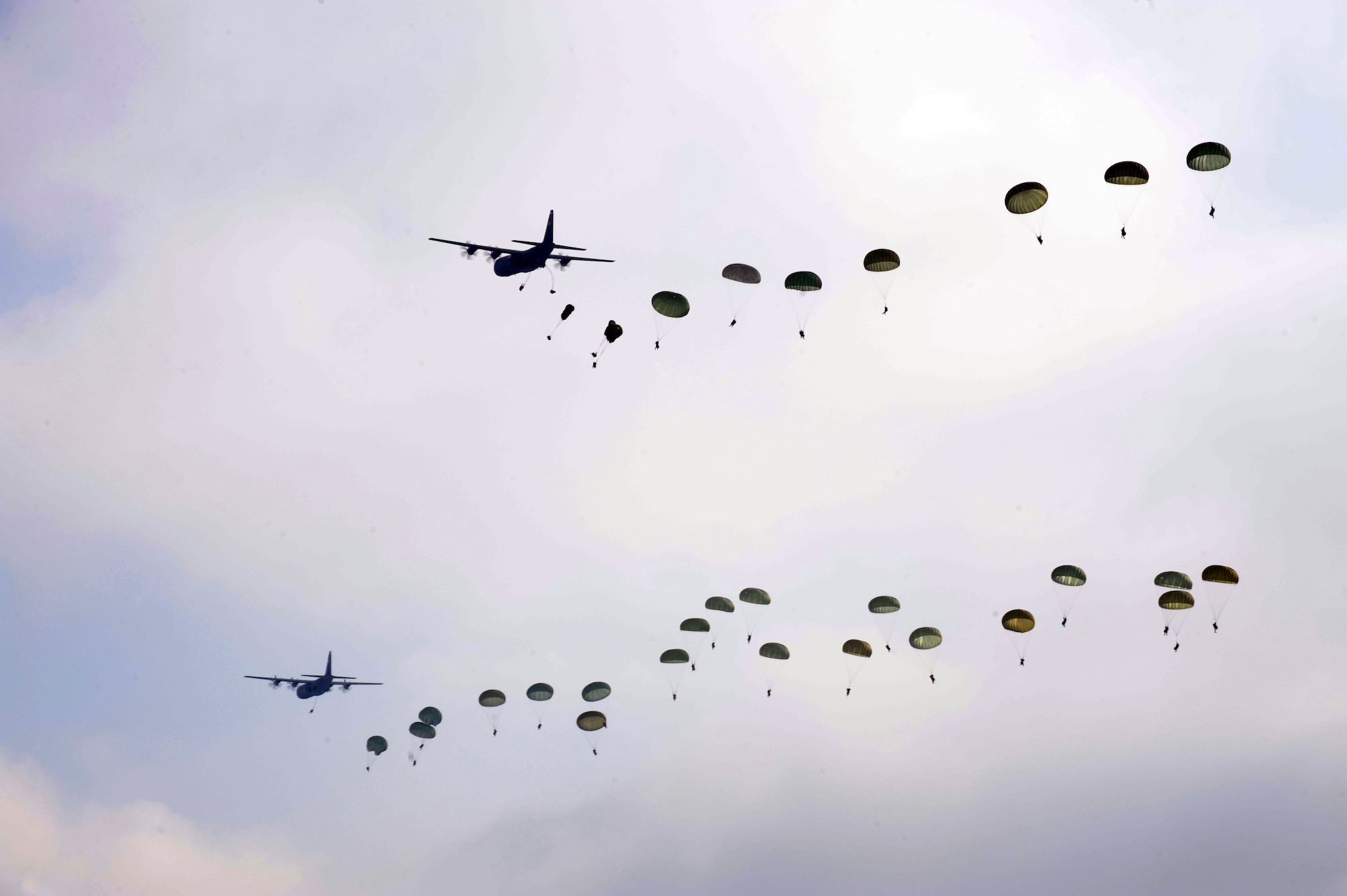 U.S. Air Force C-130J Super Hercules assigned to the 37th Airlift Squadron, Ramstein Air Base, Germany, conduct a mass airdrop of paratroopers from the U.S. Army's 173rd Airborne Brigade Combat Team, out of Aviano Air Base, Italy, Feb. 10, 2012. The mass airdrop over Alzey, Germany, commemorated 70 years of combat airlift capabilities for the 37th AS. (U.S. Air Force photo by Airman 1st Class Caitlin O'Neil-McKeown)