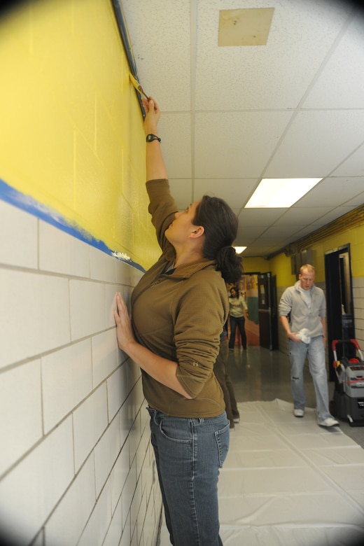 WASHINGTON -- Staff Sgt. Brittinie Alvarez, a member of the newly-formed 11th Wing Commander’s Action Group, paints the main entrance hallway at C.W. Harris Elementary School Feb. 4. Military personnel from the National Capitol Region and their families helped spruce up the school by painting the hallways and all of the doors, power-washing the exterior, removing grafitti and setting up classrooms.  (U.S. Air Force photo/Senior Airman Amber Russell)
