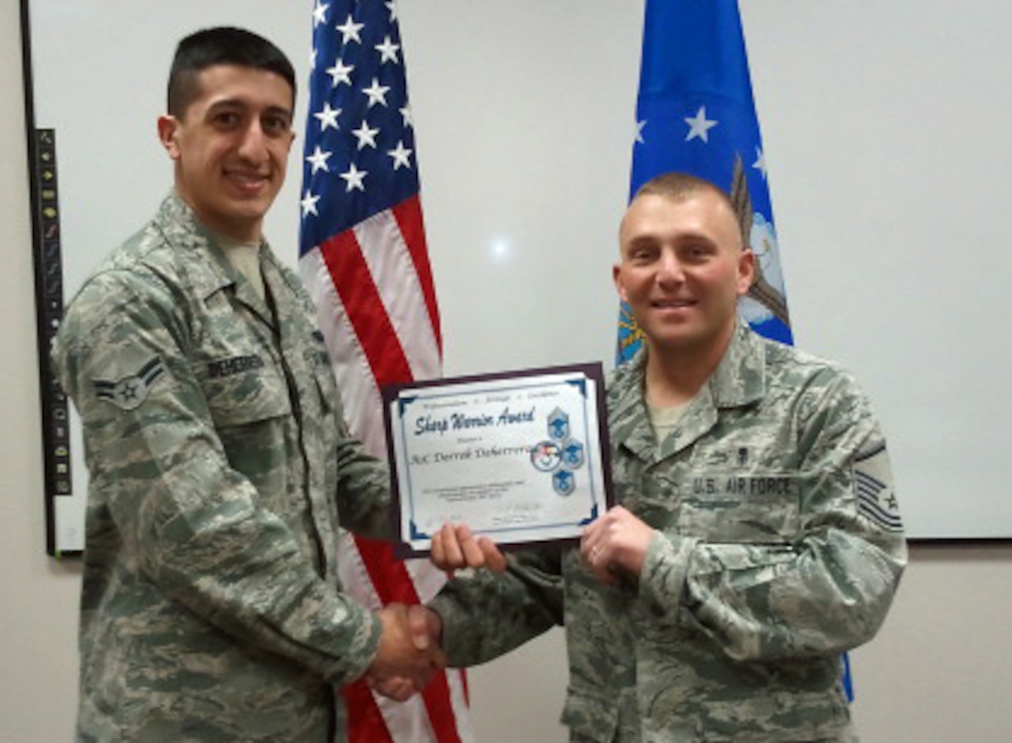 Master Sgt. Daniel Stellabotte (right), 21st Force Support Squadron, presents the Pikes Peak Top-3 Sharp Warrior Award for November to Airman 1st Class Derrek DeHerrera, 21st Communications Squadron client systems technician. DeHerrera recently emceed a promotion ceremony on short notice, flawlessly narrating the event. Additionally, he received the Dorm of the Quarter award from the 21st CS commander. The Pikes Peak Top-3 goal is to promote professionalism and camaraderie throughout the enlisted ranks, and to take care of Airmen. For information about the Pikes Peak Top-3 or its sharp warrior award, call Master Sgt. Charles Apodaca at 556-0059. (U.S. Air Force photo) 
