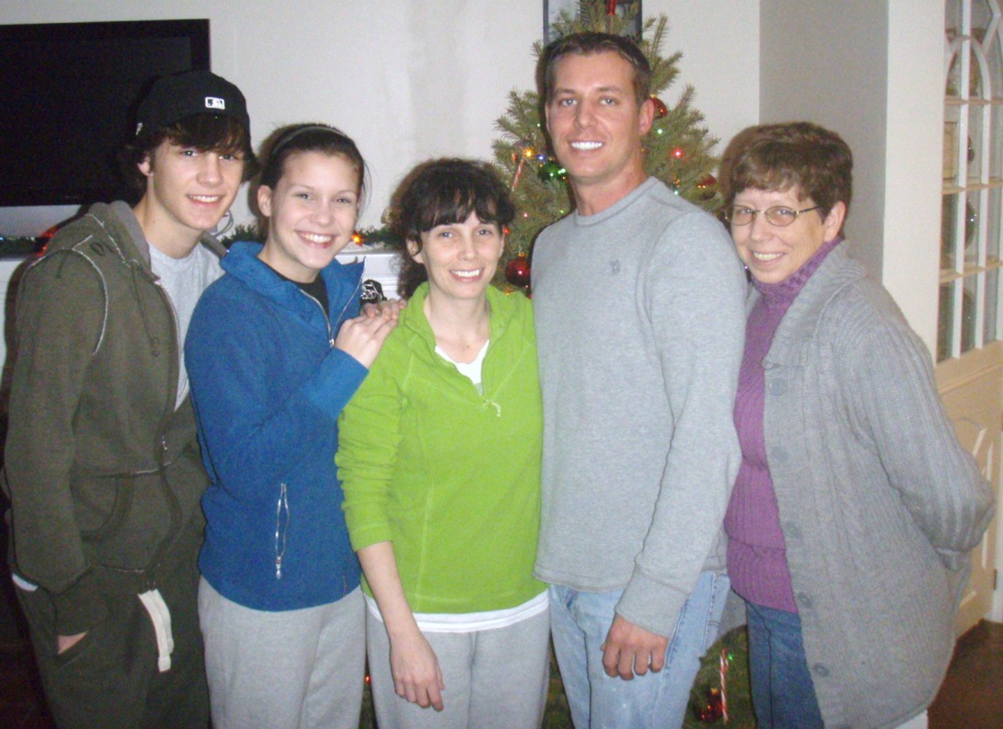 Former Marine Sgt. Brian Sellers stands with family members during Christmas time. Sellers completed months of speech and physical therapy after an attack caused him to lose 70% of the use of his tongue.