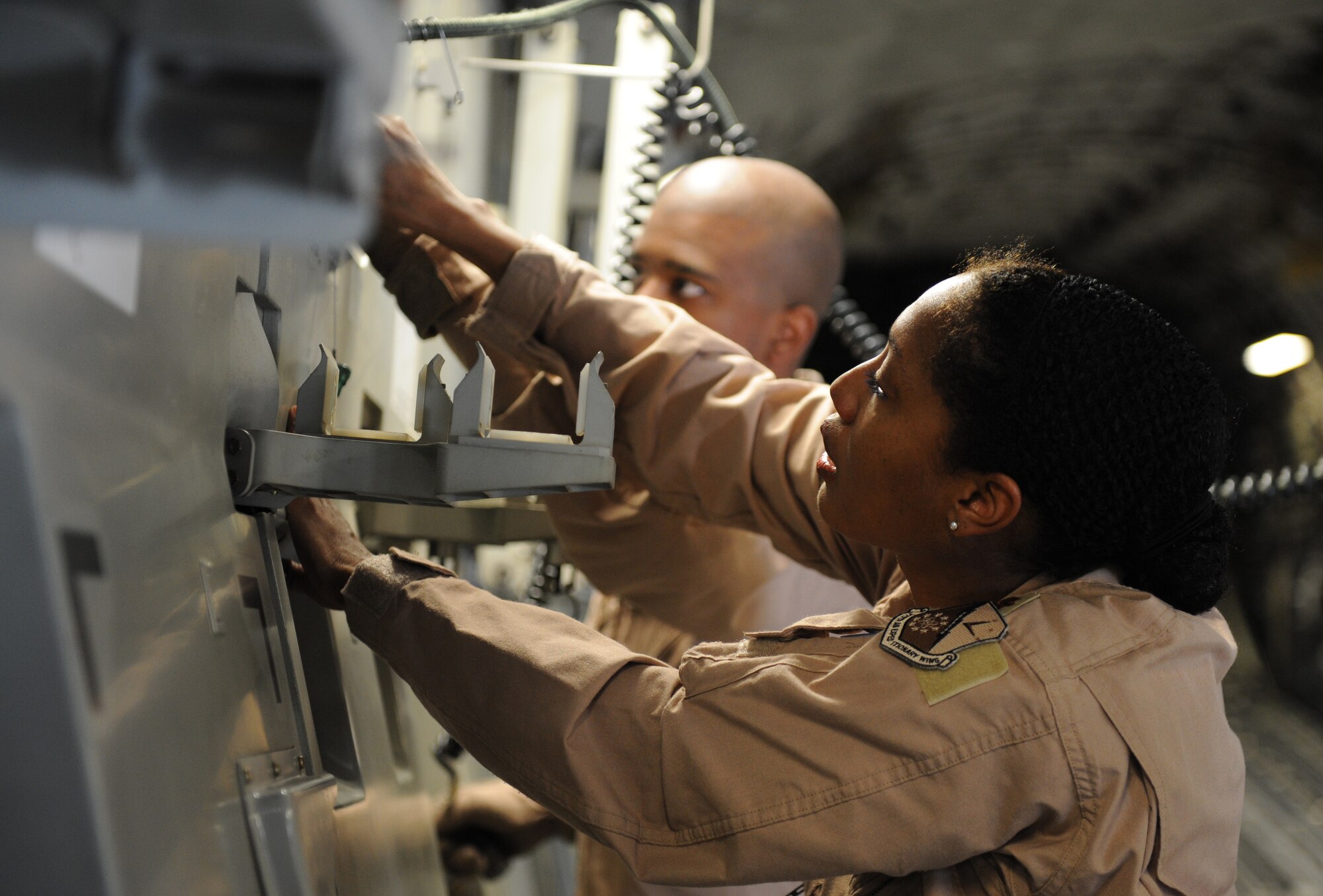 SOUTHWEST ASIA – Maj. Debra Sims, 379th Expeditionary Aeromedical Evacuation Squadron flight nurse, and Staff Sgt. Donald Ennis, 379th EAES medical technician, prepare to assemble a litter station on a C-17 Globemaster here Feb. 10, 2012. Litter stations are used to transport intensive care patients aboard an aircraft. Three were used during the priority evacuation of hostages rescued from Somalia.  (U.S. Air Force photo/Staff Sgt. Nathanael Callon)