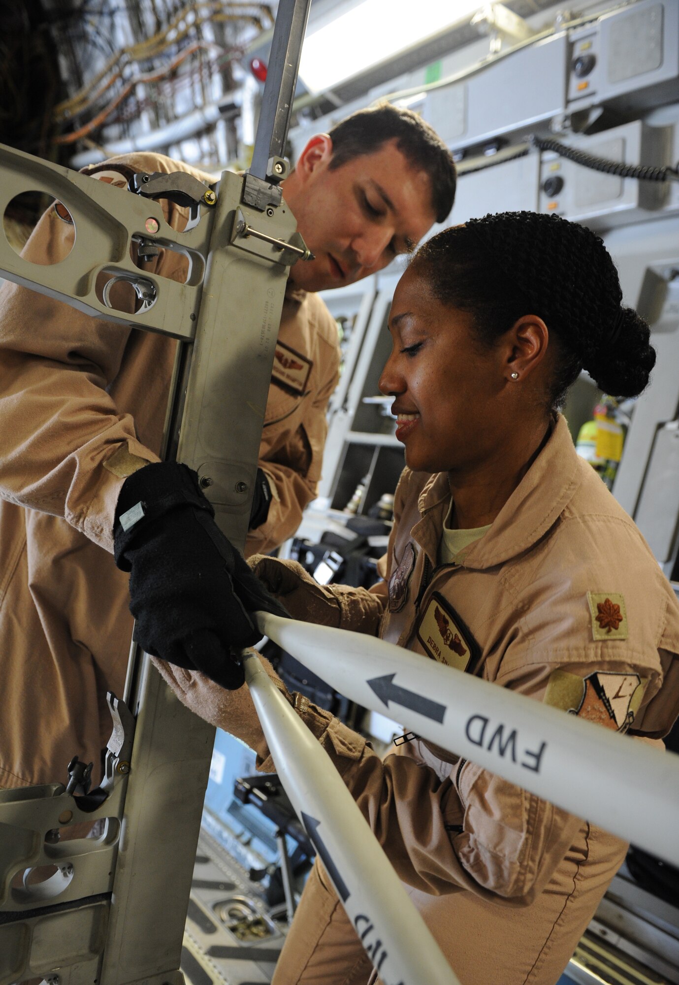 SOUTHWEST ASIA – Maj. Debra Sims, 379th Expeditionary Aeromedical Evacuation Squadron flight nurse and Dallas native, and Staff Sgt. Richard Brampton, a 379th EAES medical technician and Camano Island, Wash. native, assemble a litter station on a C-17 Globemaster here Feb. 10, 2012. Sims and Brampton recently took part in a priority evacuation of hostages rescued from Somalia. Sims and Brampton are currently deployed from Scott Air Force Base, Ill. (U.S. Air Force photo/Staff Sgt. Nathanael Callon)