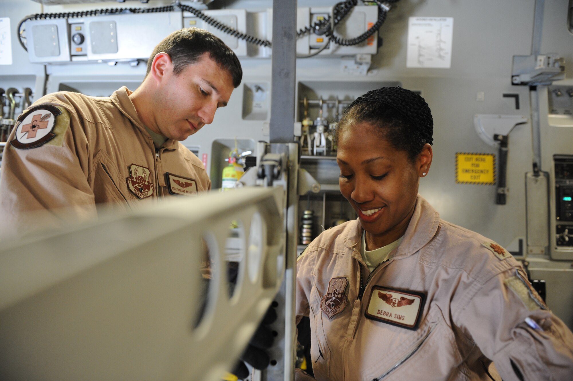 SOUTHWEST ASIA – Maj. Debra Sims, 379th Expeditionary Aeromedical Evacuation Squadron flight nurse and Dallas native, and Staff Sgt. Richard Brampton, a 379th EAES medical technician and Camano Island, Wash. native, assemble a litter station on a C-17 Globemaster here Feb. 10, 2012. Sims and Brampton recently took part in a priority evacuation of hostages rescued from Somalia. Sims and Brampton are currently deployed from Scott Air Force Base, Ill. (U.S. Air Force photo/Staff Sgt. Nathanael Callon)