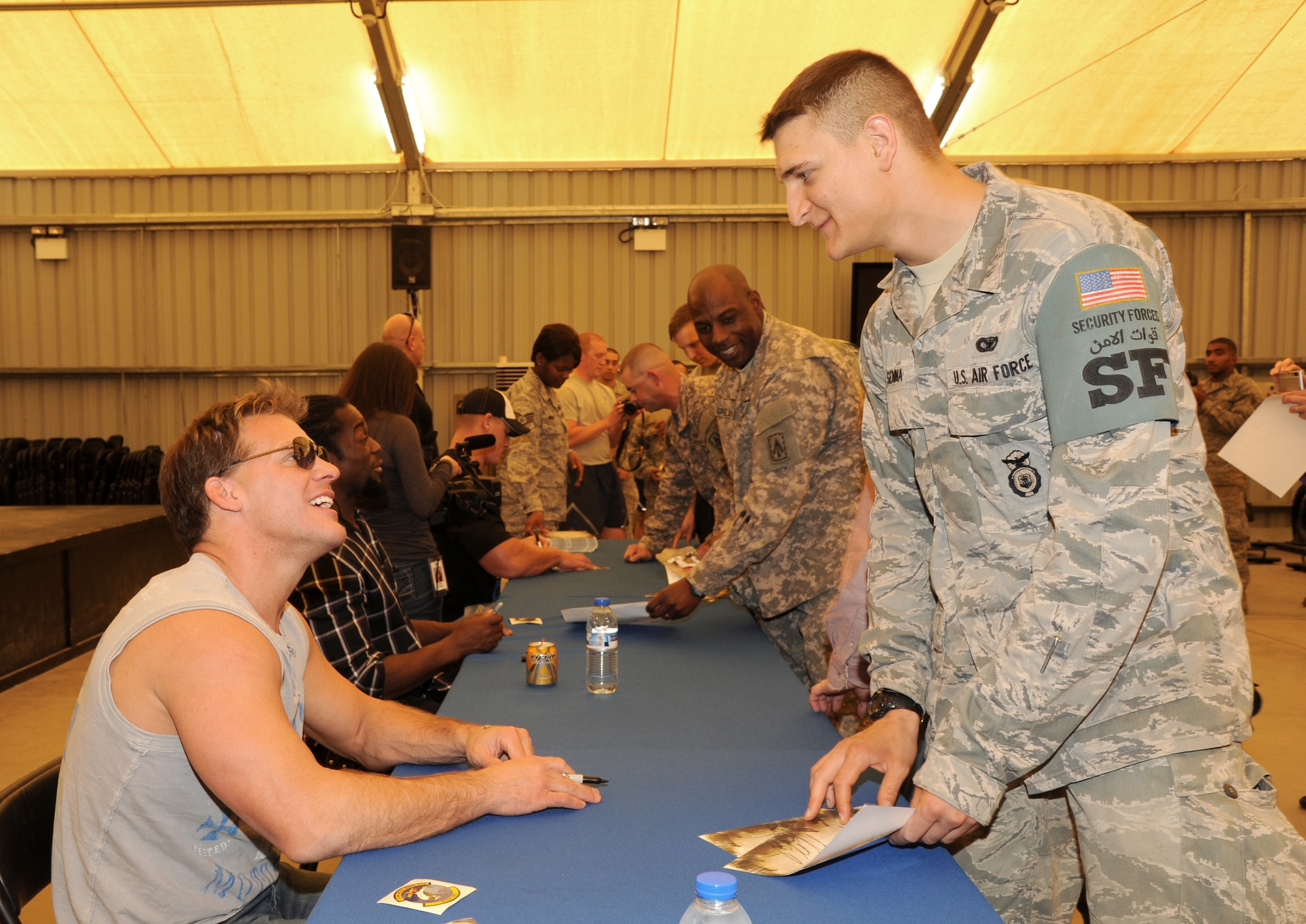 SOUTHWEST ASIA - Airman 1st Class Jacob Senna gets an autograph from World Wrestling Entertainment superstar Chris Jericho during a USO visit Feb. 10, 2012. The wrestlers took photos and signed autographs with more than 200 Airmen and Soldiers assigned to the 380th Air Expeditionary Wing. (U.S. Air Force photo/Tech. Sgt. Arian Nead)